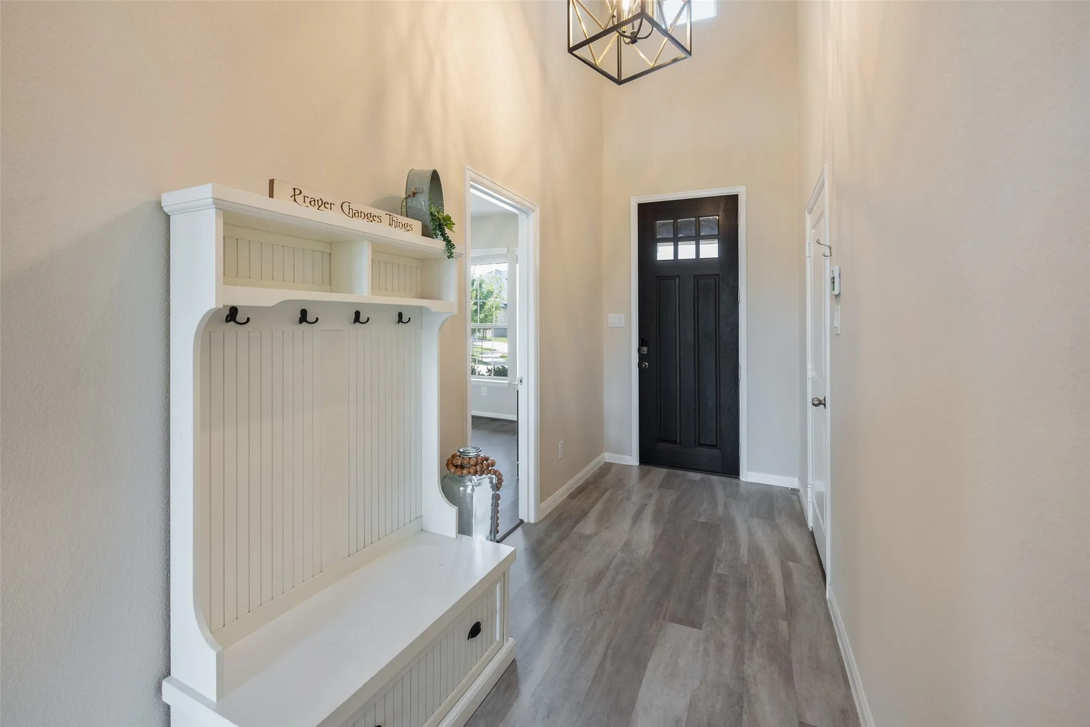 Grand entryway with new upgraded flooring, designer light fixtures, and fresh paint!