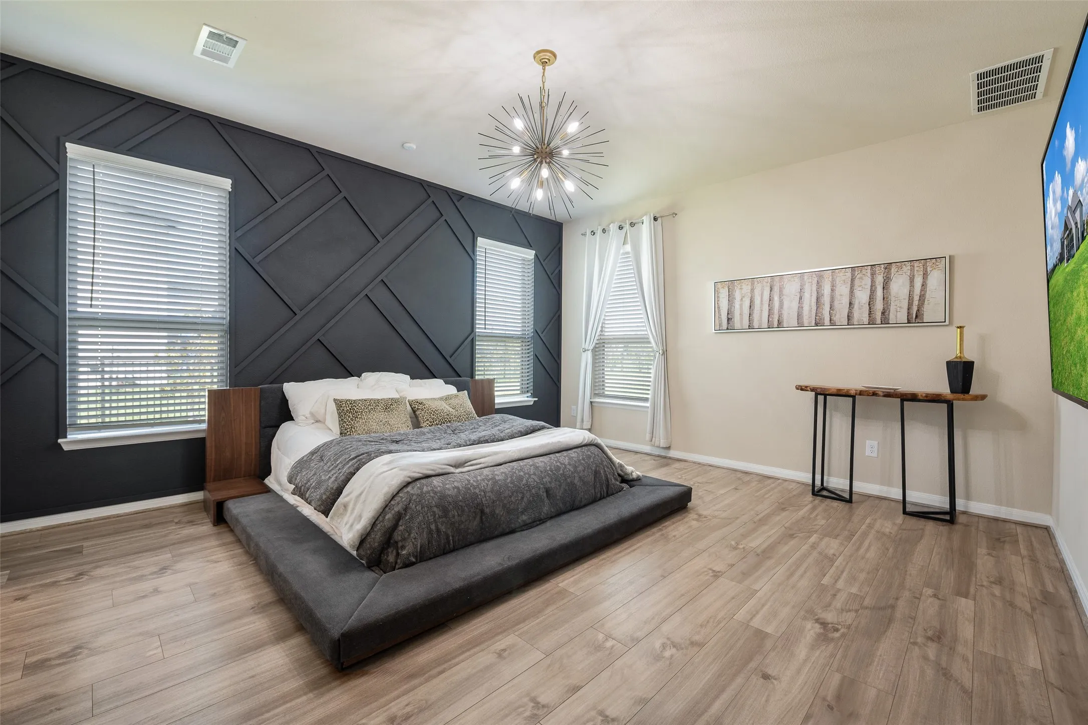 Master suite features an eye-catching custom accent wall and designer lighting!