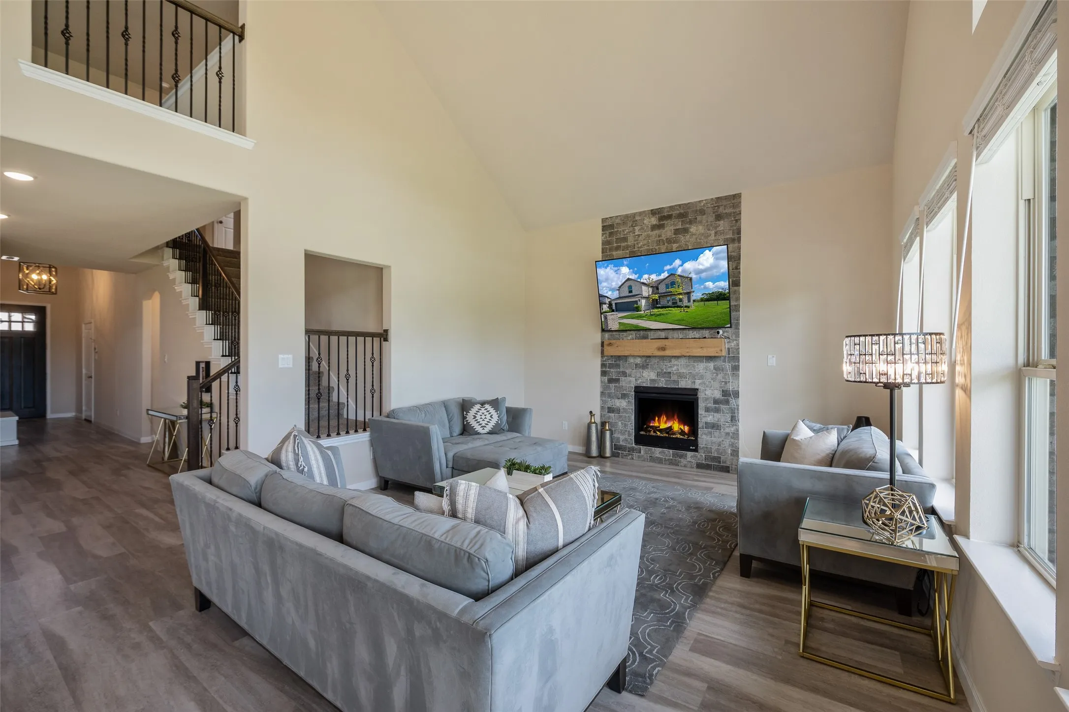 Spacious living room with opening to the game room which overlooks the living room and yard.