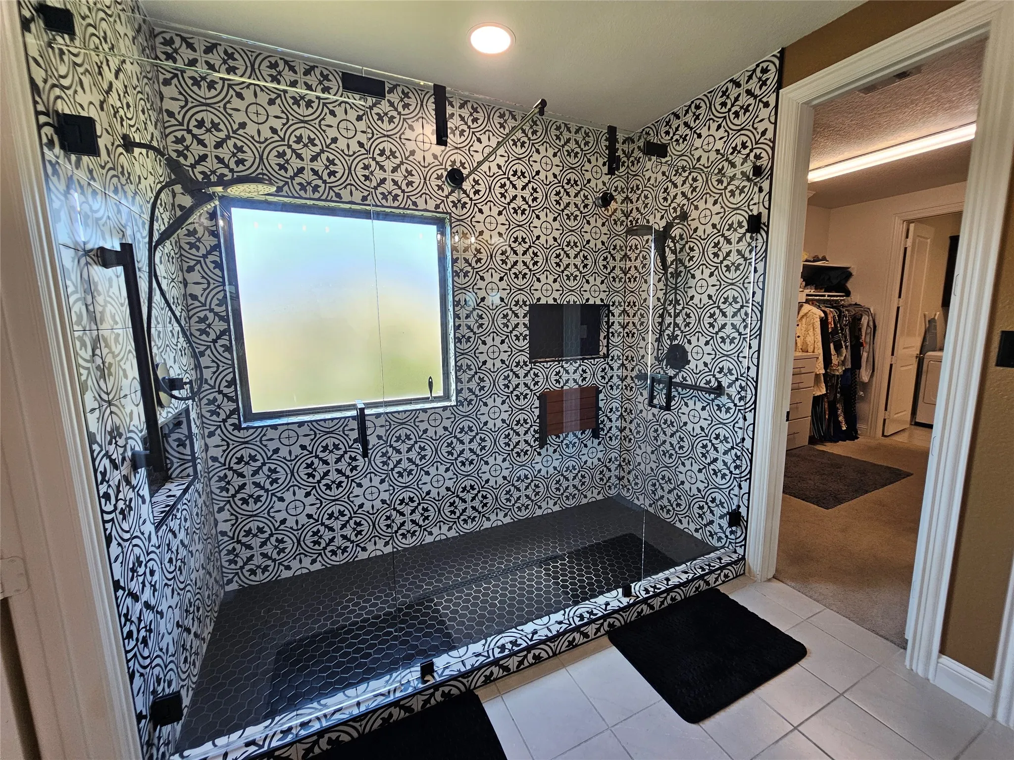 Luxury Spa-Style Walk-In Shower with Custom Tile Design Featuring Dual Shower Heads