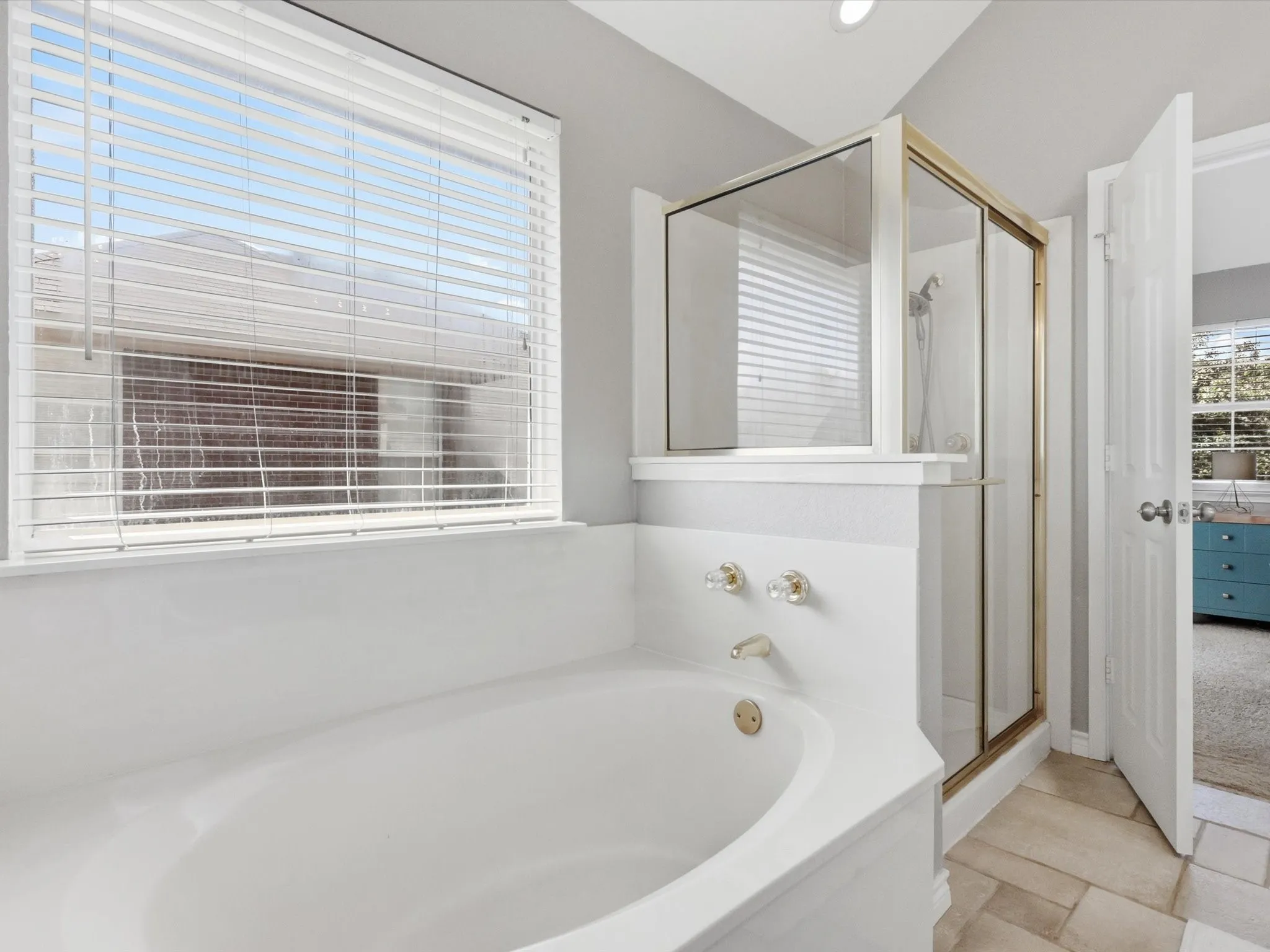 Primary Bathroom featuring soaking tub and walk in shower