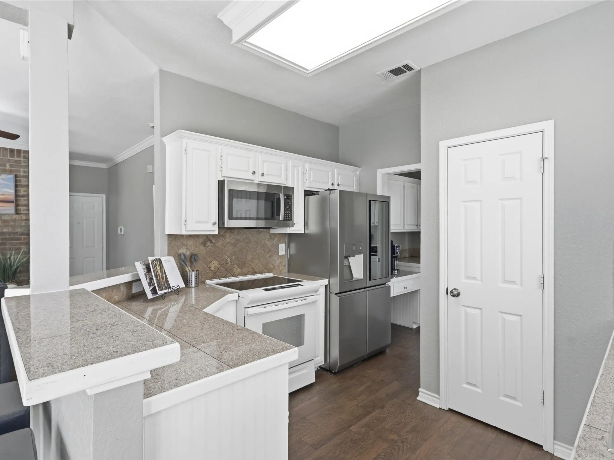 Kitchen featuring tile countertops and a range