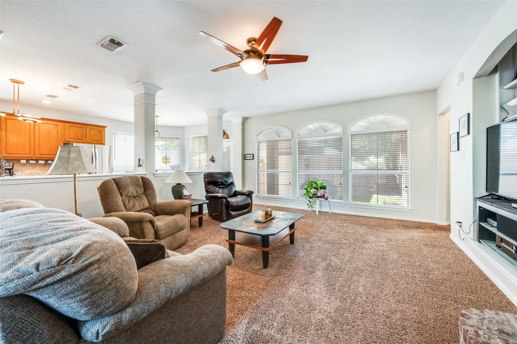 Open and spacious family room close to the kitchen offers built in areas for TV and equipment.  Great back garden view too!