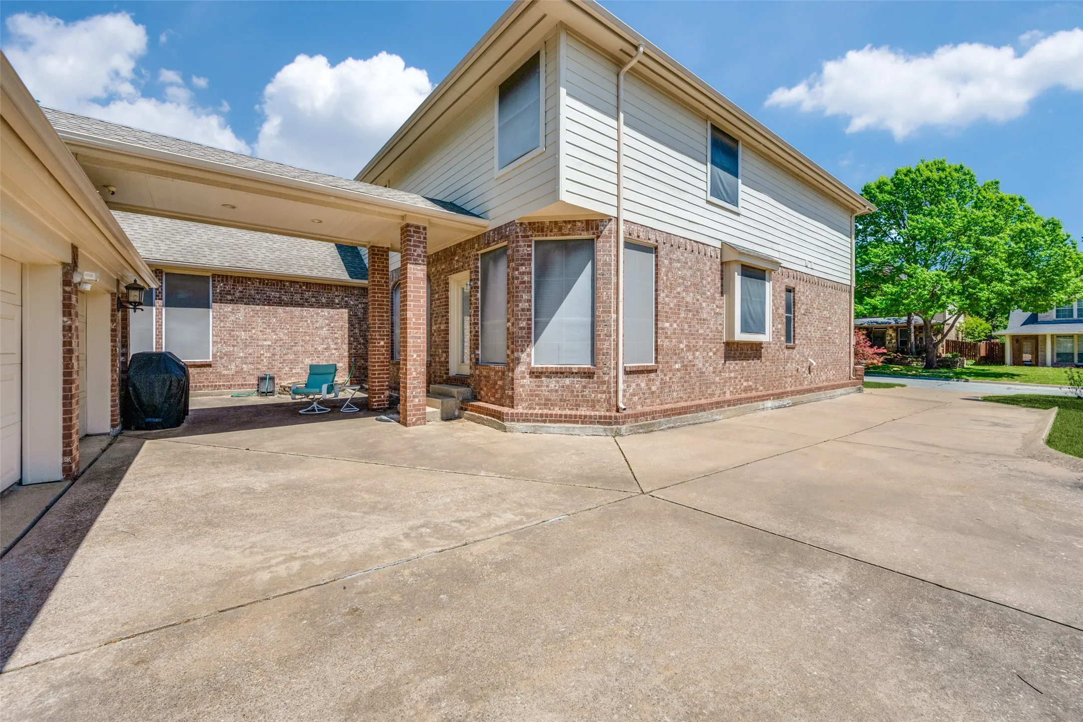Big three car garage with extra parking and covered walk to back door that leads directly into the kitchen.  Great shaded grilling area too!