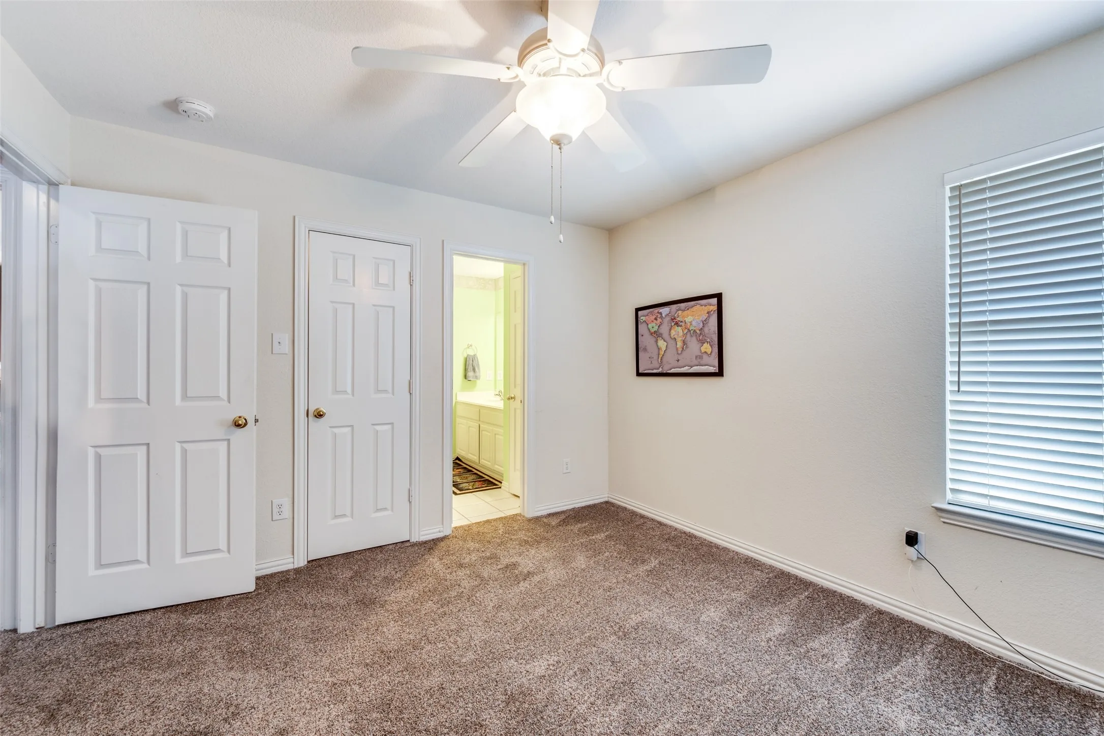 This bedroom has direct access to a bathroom!