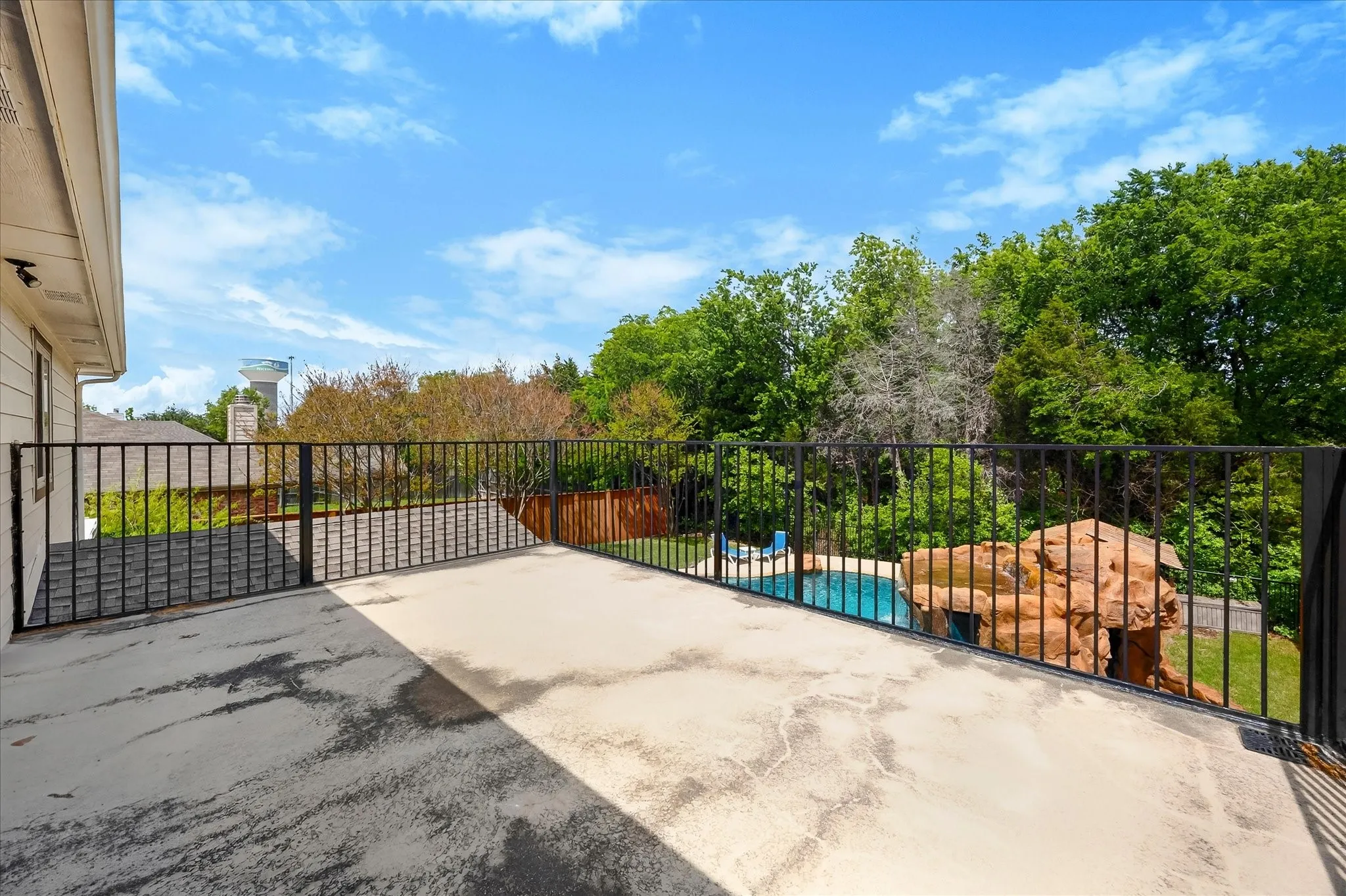 Upstairs balcony overlooks private backyard and pool