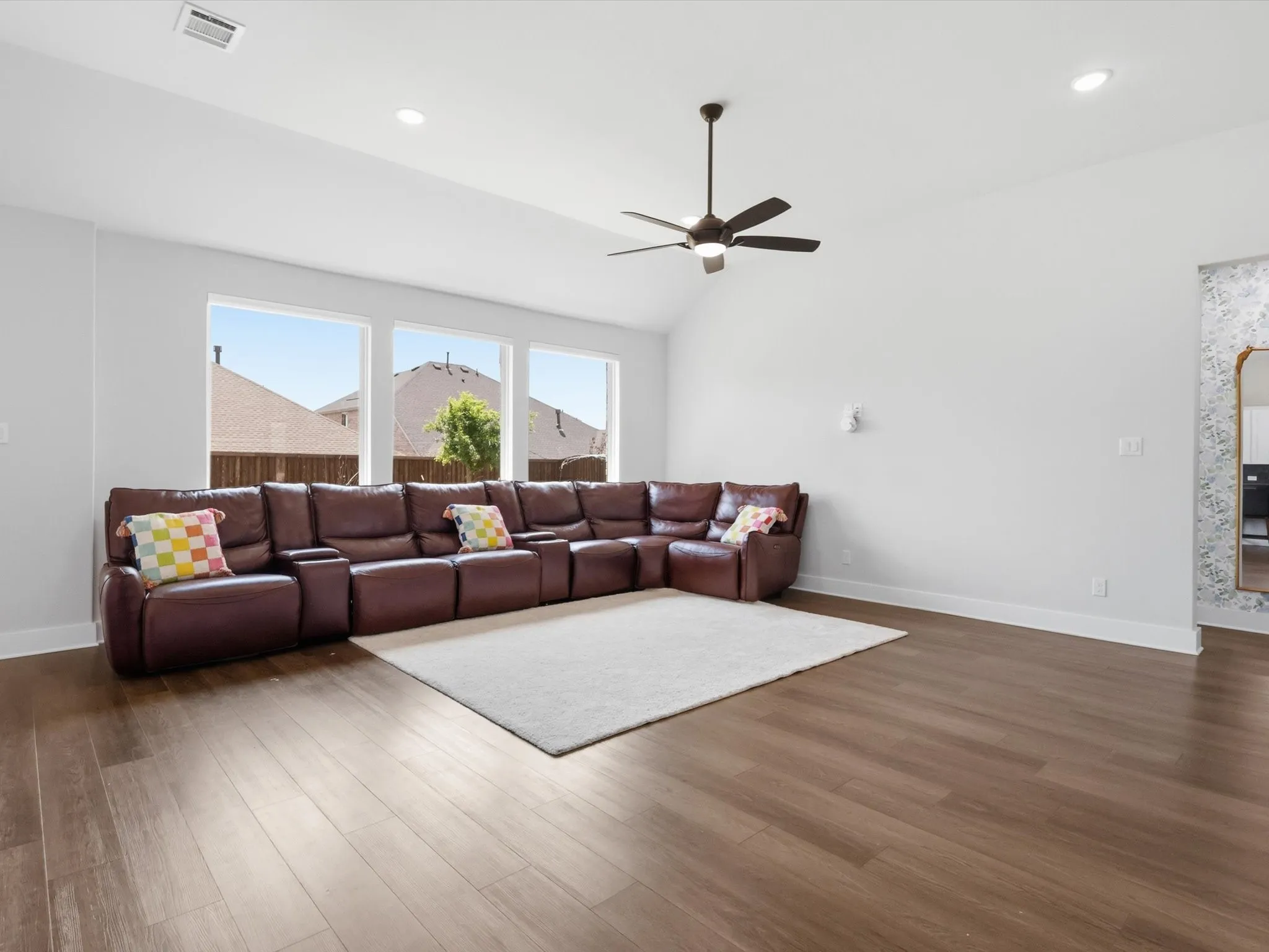 Bright and airy main living space with backyard views