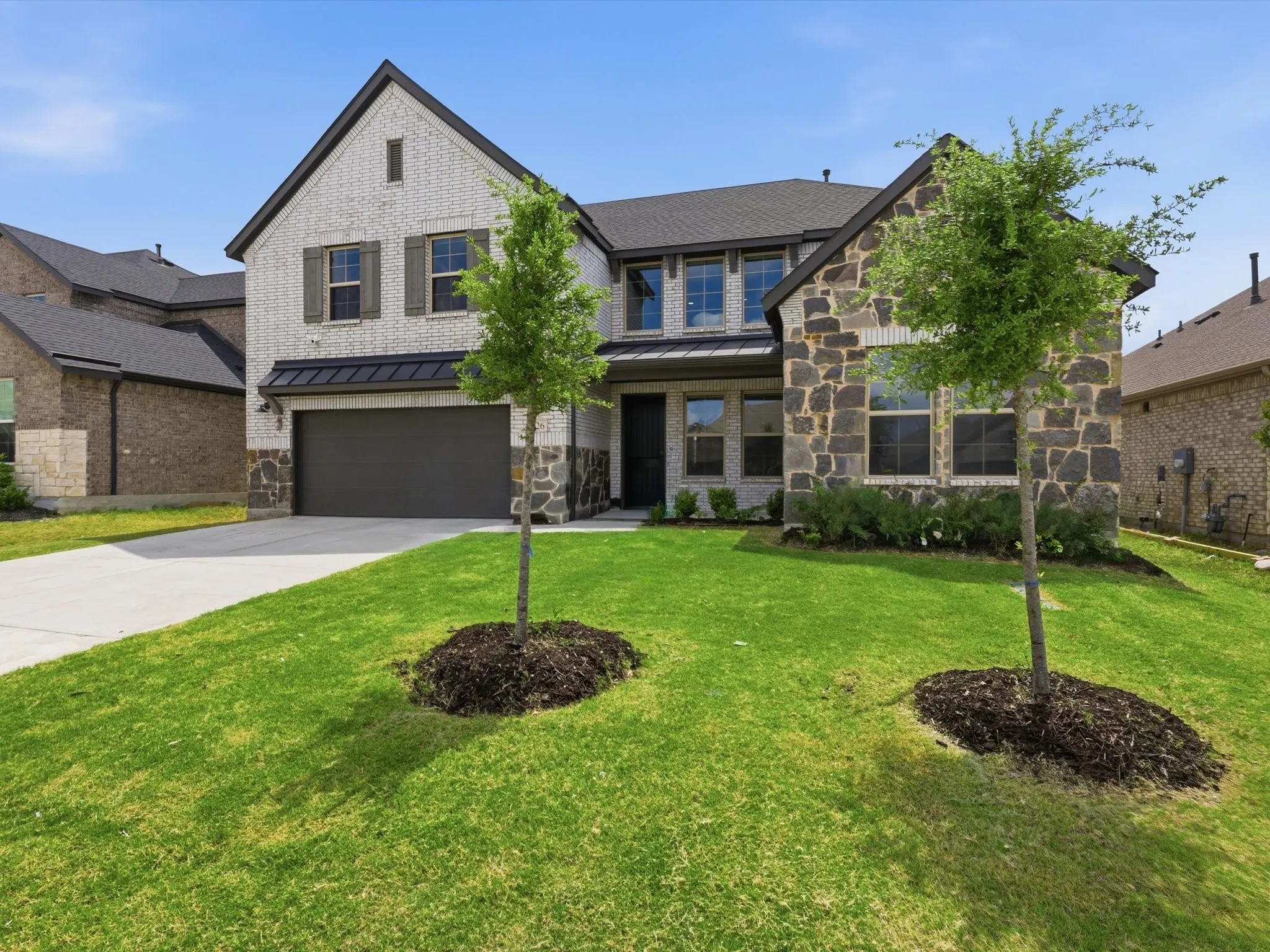 Beautiful curb appeal with modern brick and stone elevation