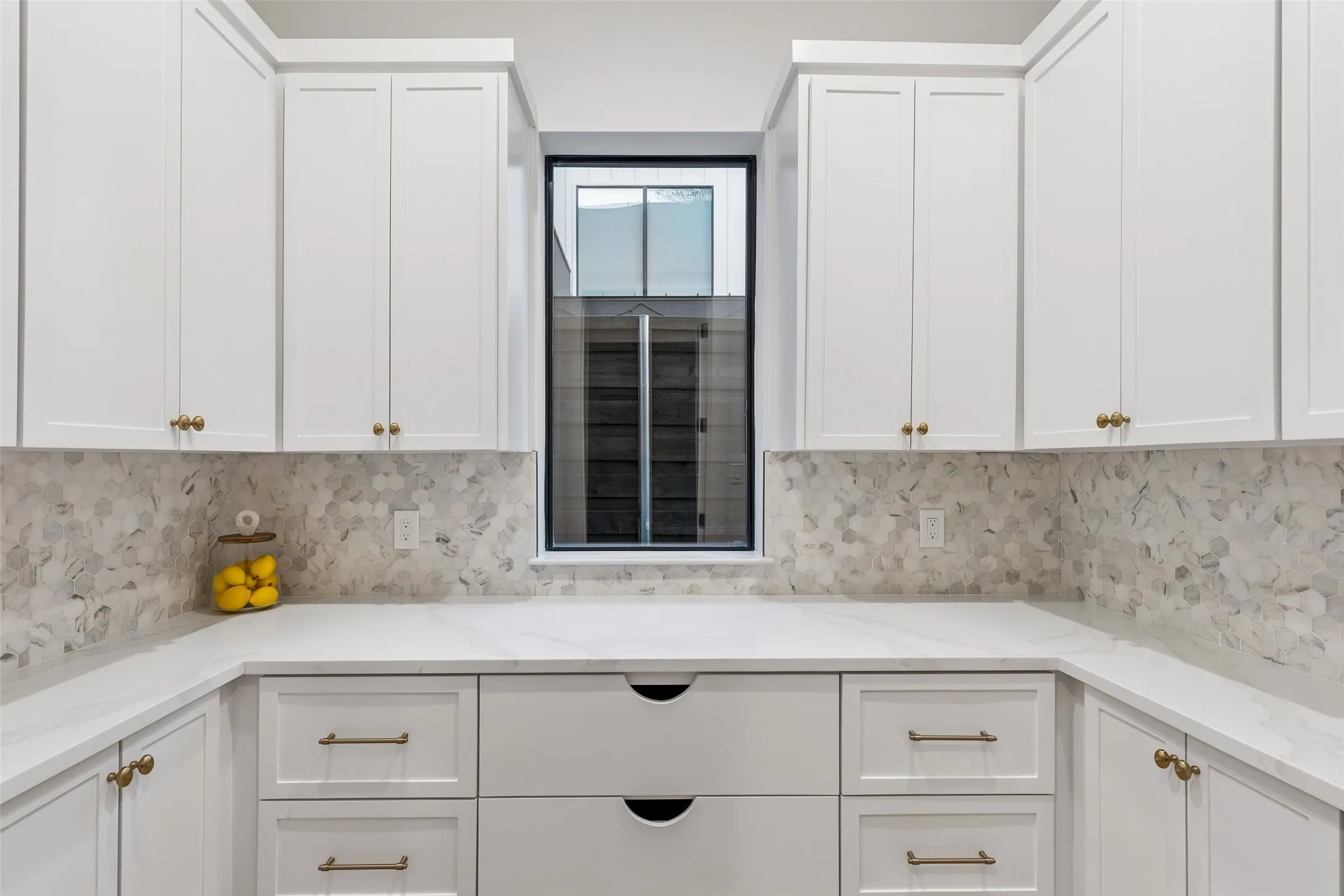 Spacious walk-in pantry with custom cabinetry, abundant storage, and convenient prep space.