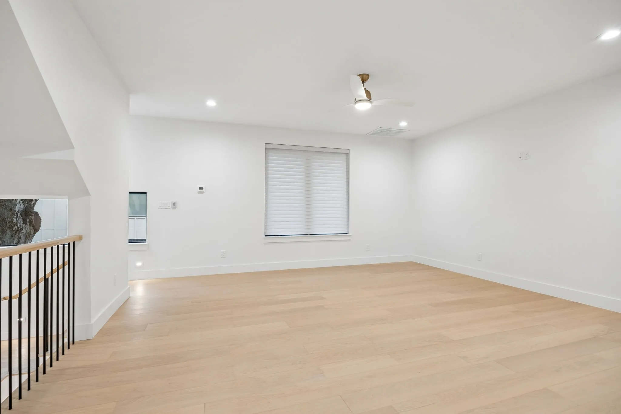 Another view of the second floor bonus living room with picturesque windows.