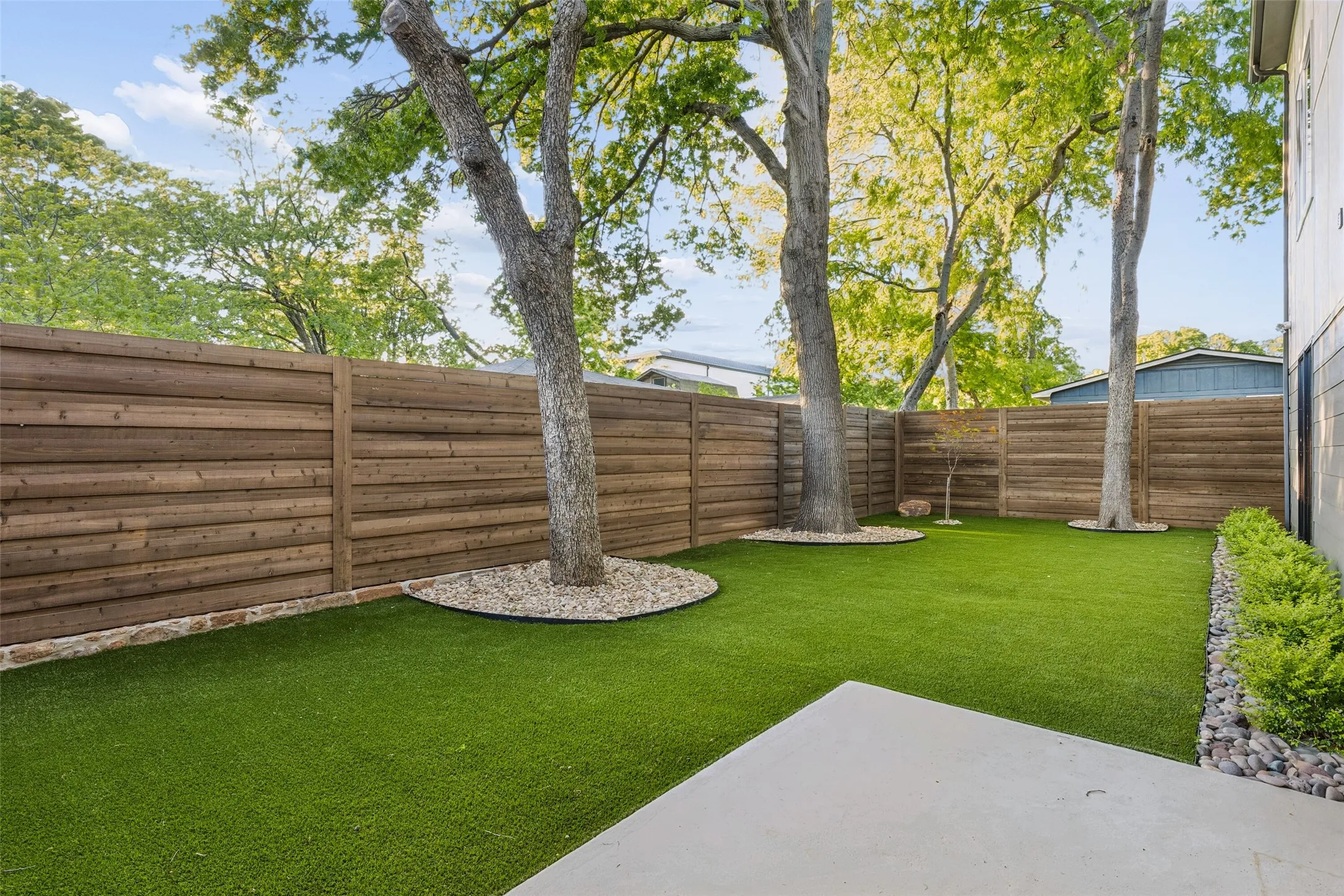 Low-maintenance turfed backyard with mature trees, offering a private and inviting outdoor​​‌​​​​‌​​‌‌​‌‌​​​‌‌​‌​‌​‌​​​‌​​ retreat.