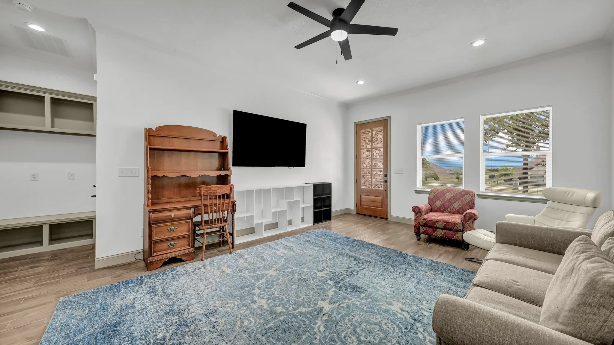 Living area featuring light wood-type flooring, recessed lighting, and a ceiling fan