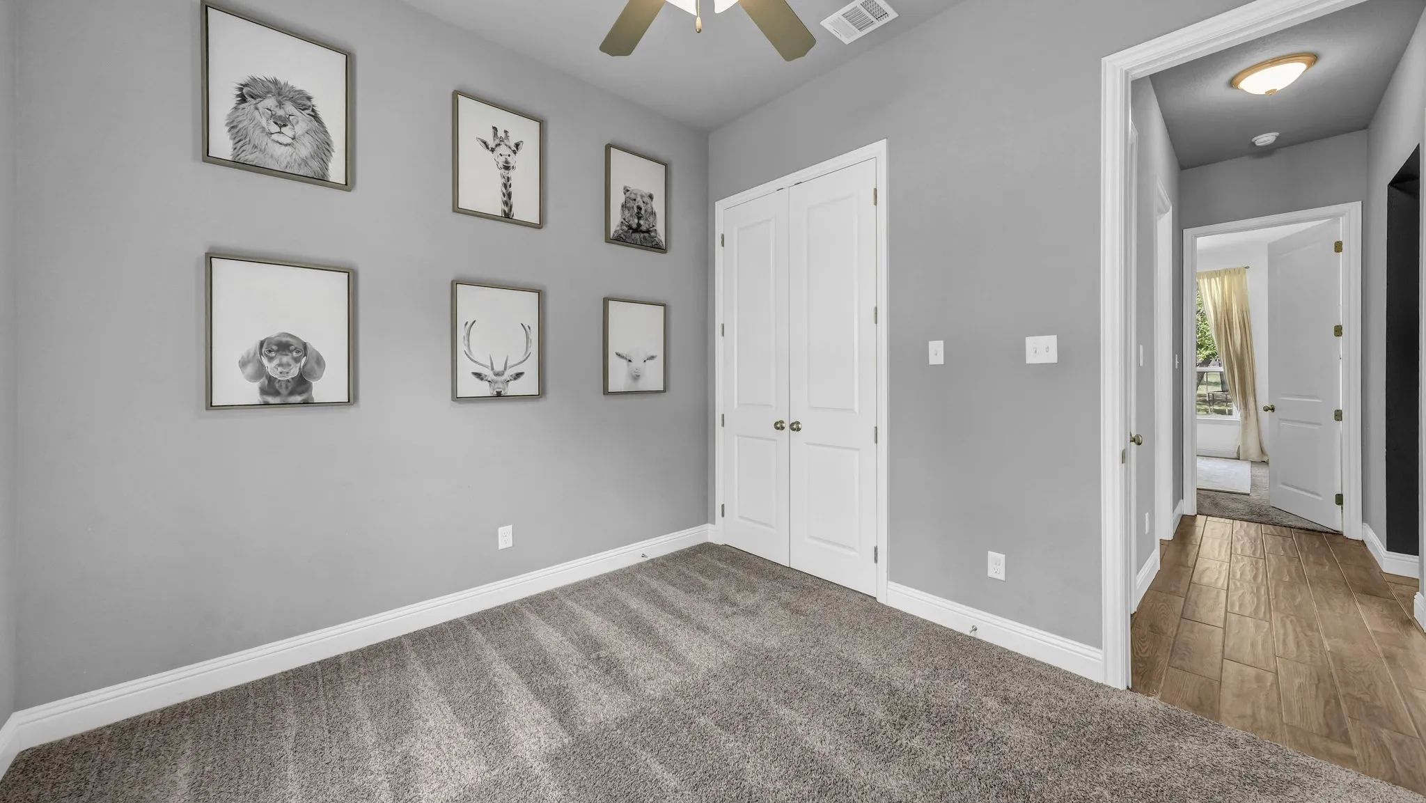 Unfurnished bedroom featuring carpet, a closet, and ceiling fan