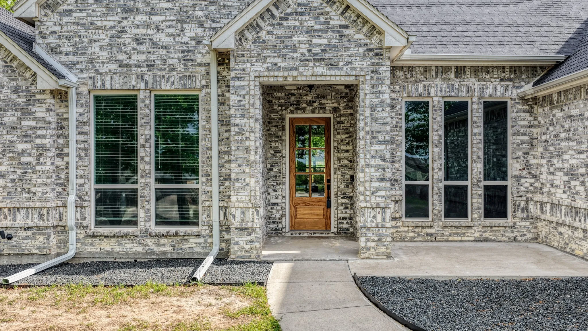 Entrance to property featuring brick siding