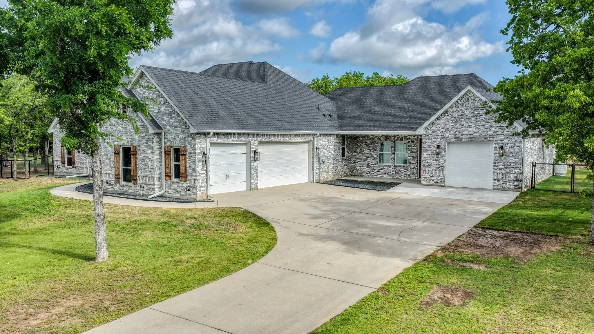 View of front of home with an attached garage, a front yard, and concrete driveway