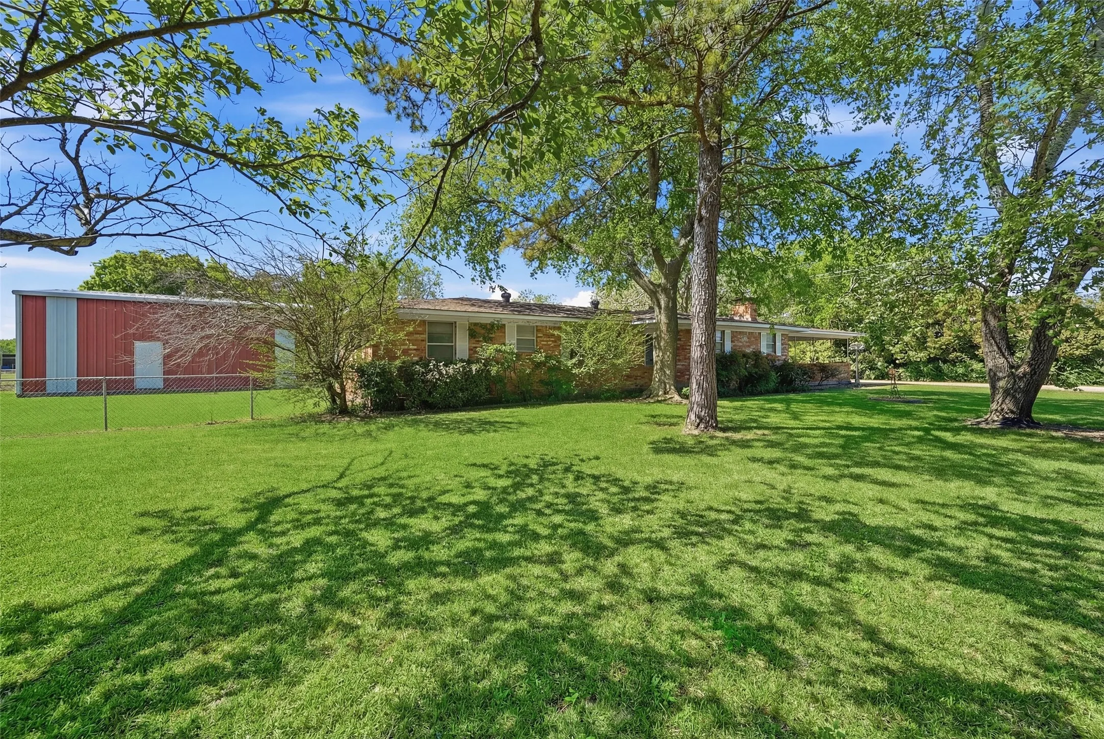 View from east side of house and toward workshop in back