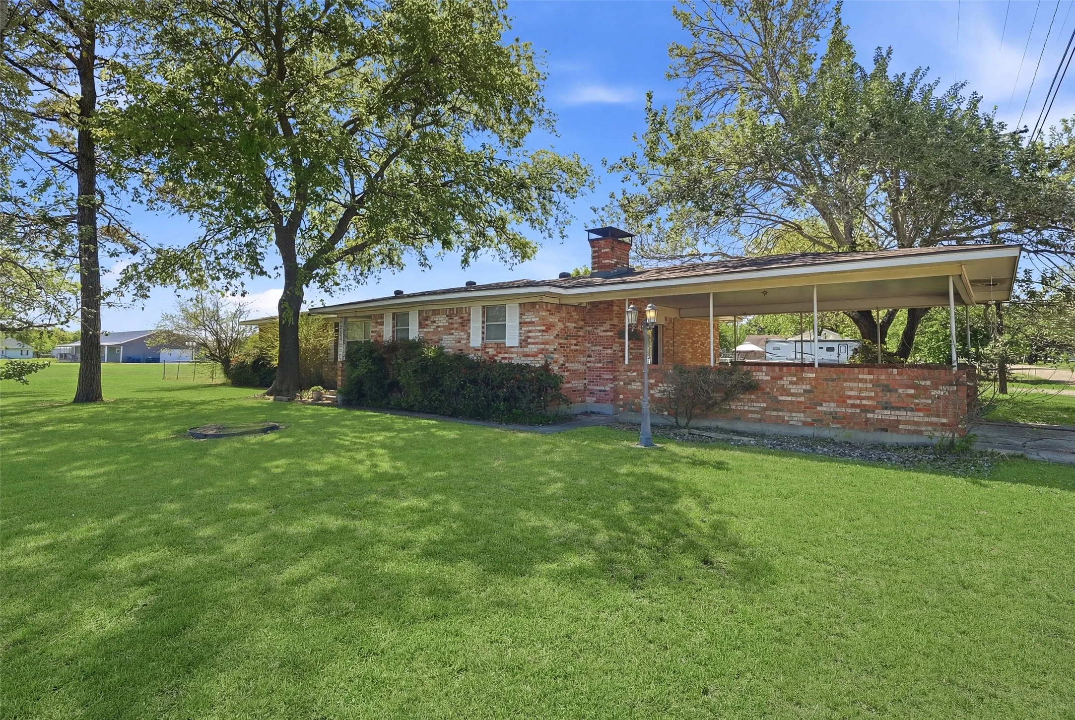 View from west side of house and Carport