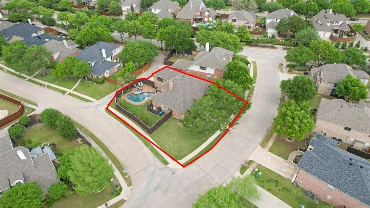 Aerial perspective of suburban area featuring property parcel outlined