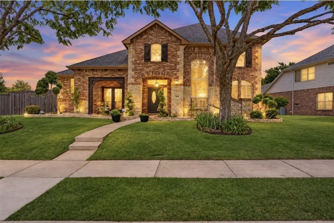 Brick and stone exterior with arched windows and entryway