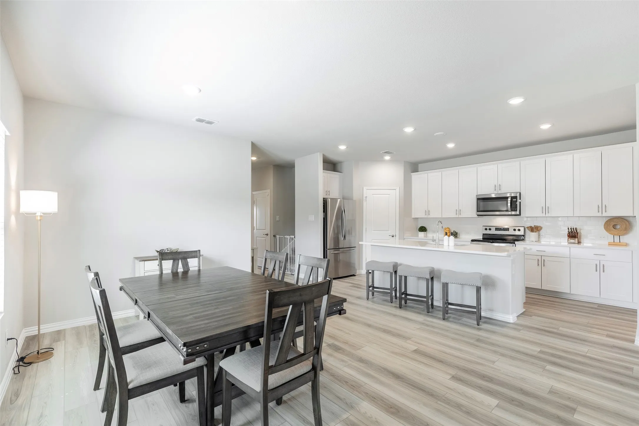 Casual dining with soft natural light throughout the day open to the kitchen.