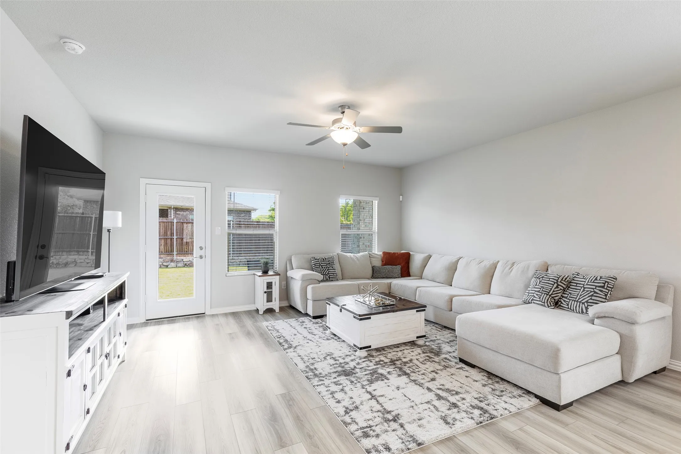 Light-filled family room with access to the large backyard with a covered patio.