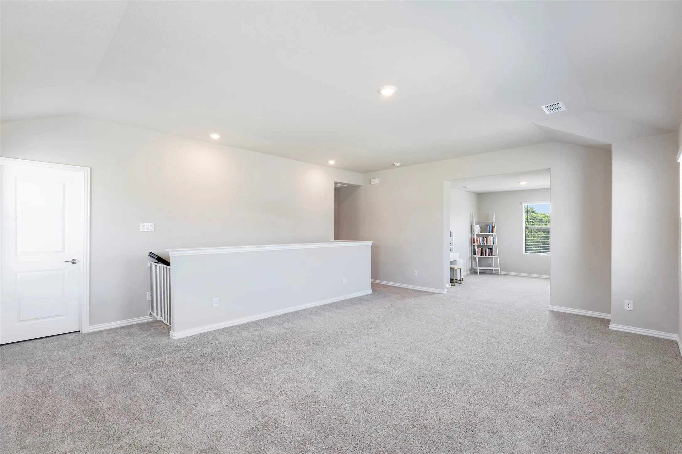 Upstairs layout creates a dedicated living space with three bedrooms, full bath, and flexible use areas.