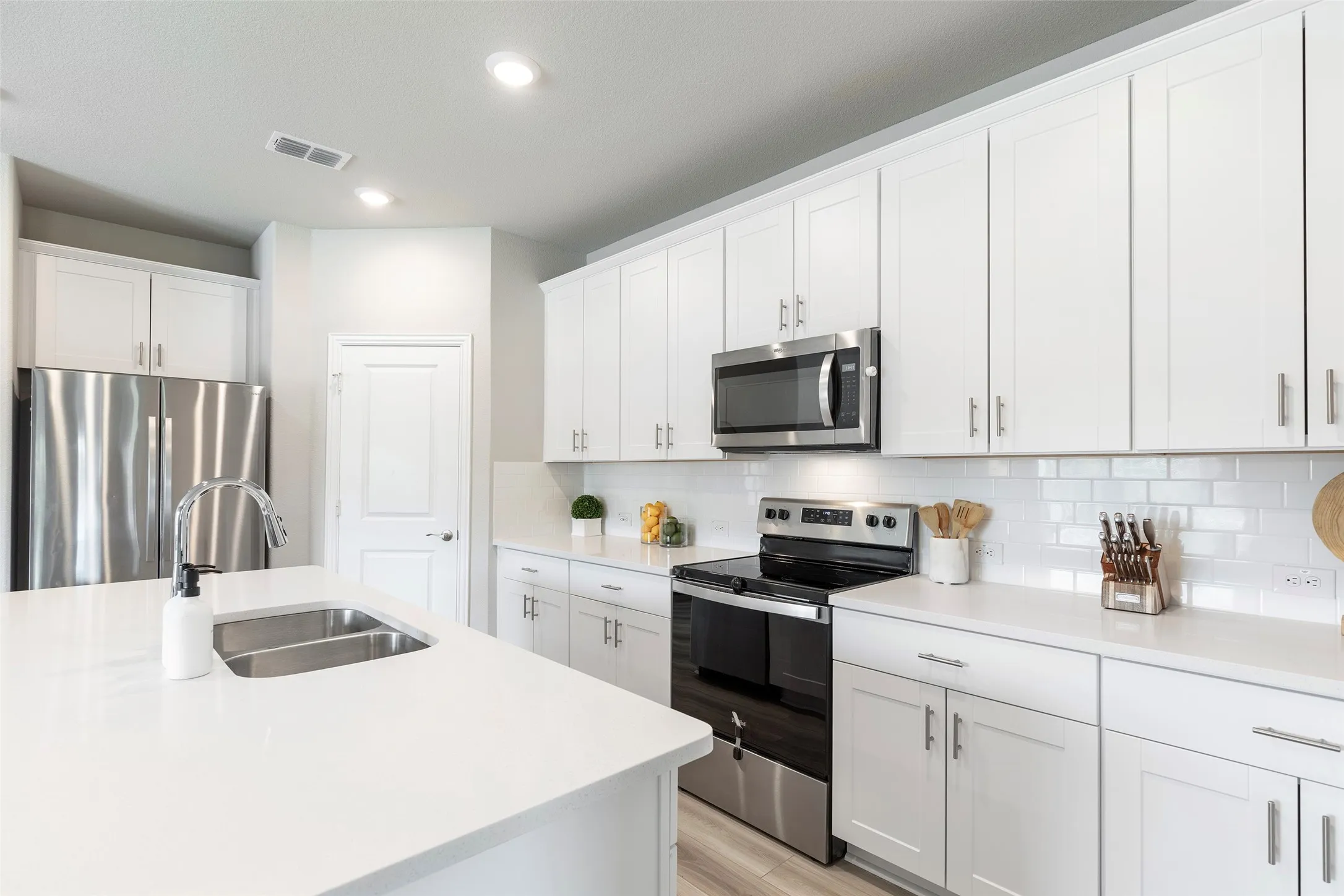 Clean-lined kitchen with abundant storage and natural light.