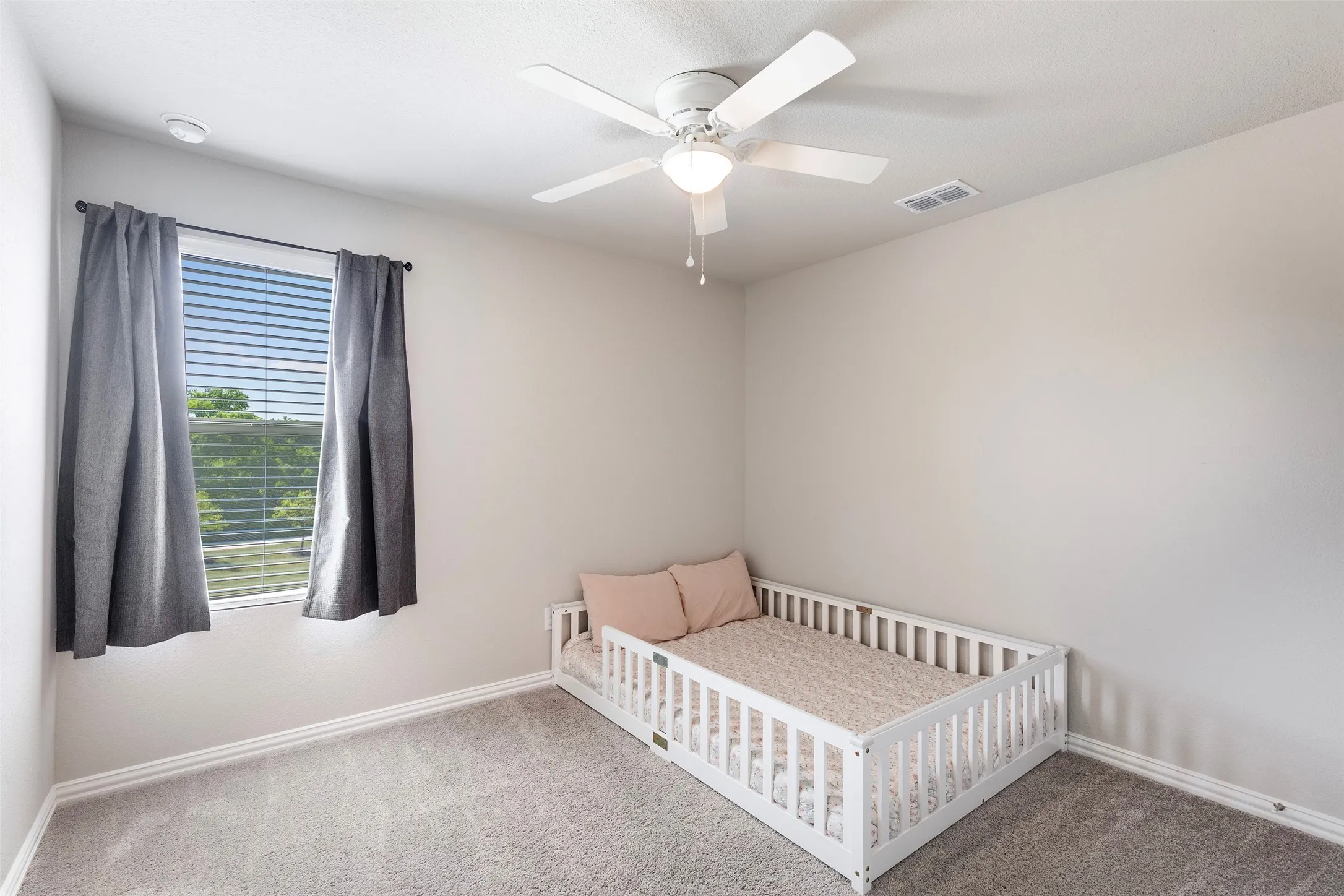 3rd Bright upstairs bedroom with peaceful neighborhood views.