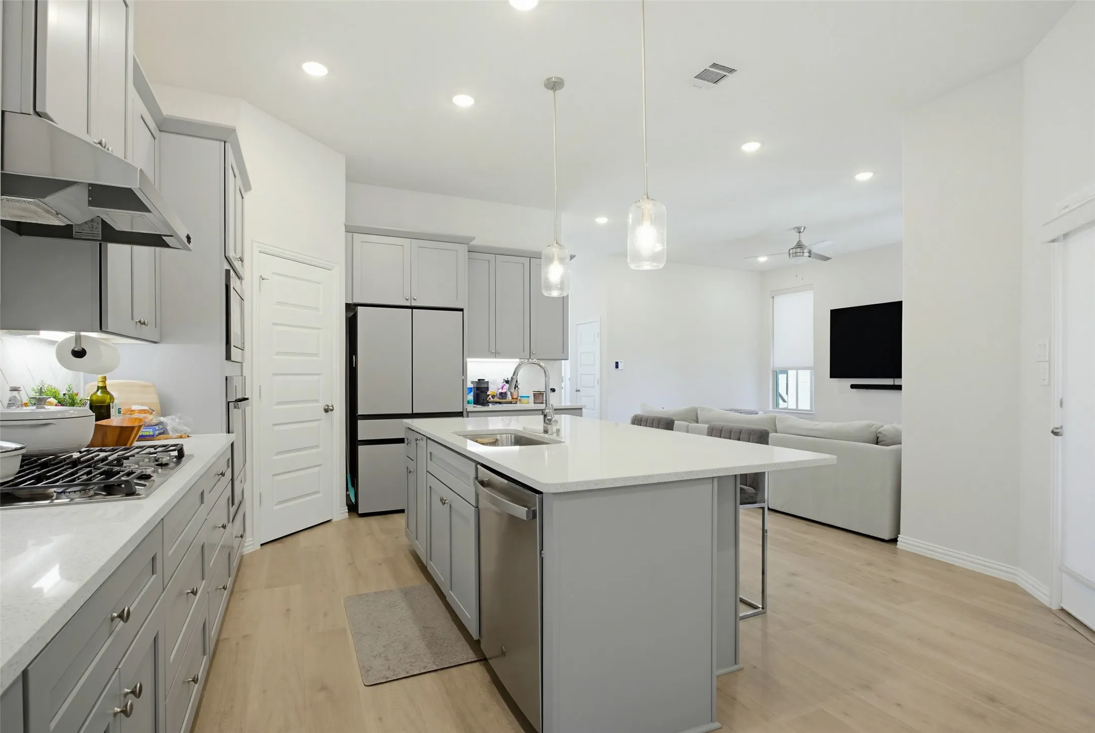 Modern kitchen featuring light gray cabinetry and white countertops