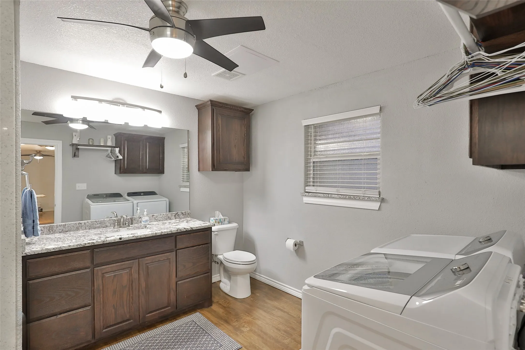Located in the warehouse/man mansion; Downstairs bathroom and laundry area with shower, side vanity with dimmable lighting throughout