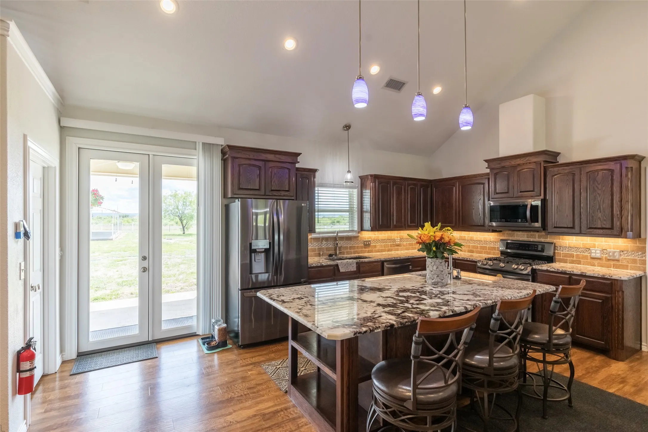 Open kitchen with Island that includes extra storage space below and a walk in pantry