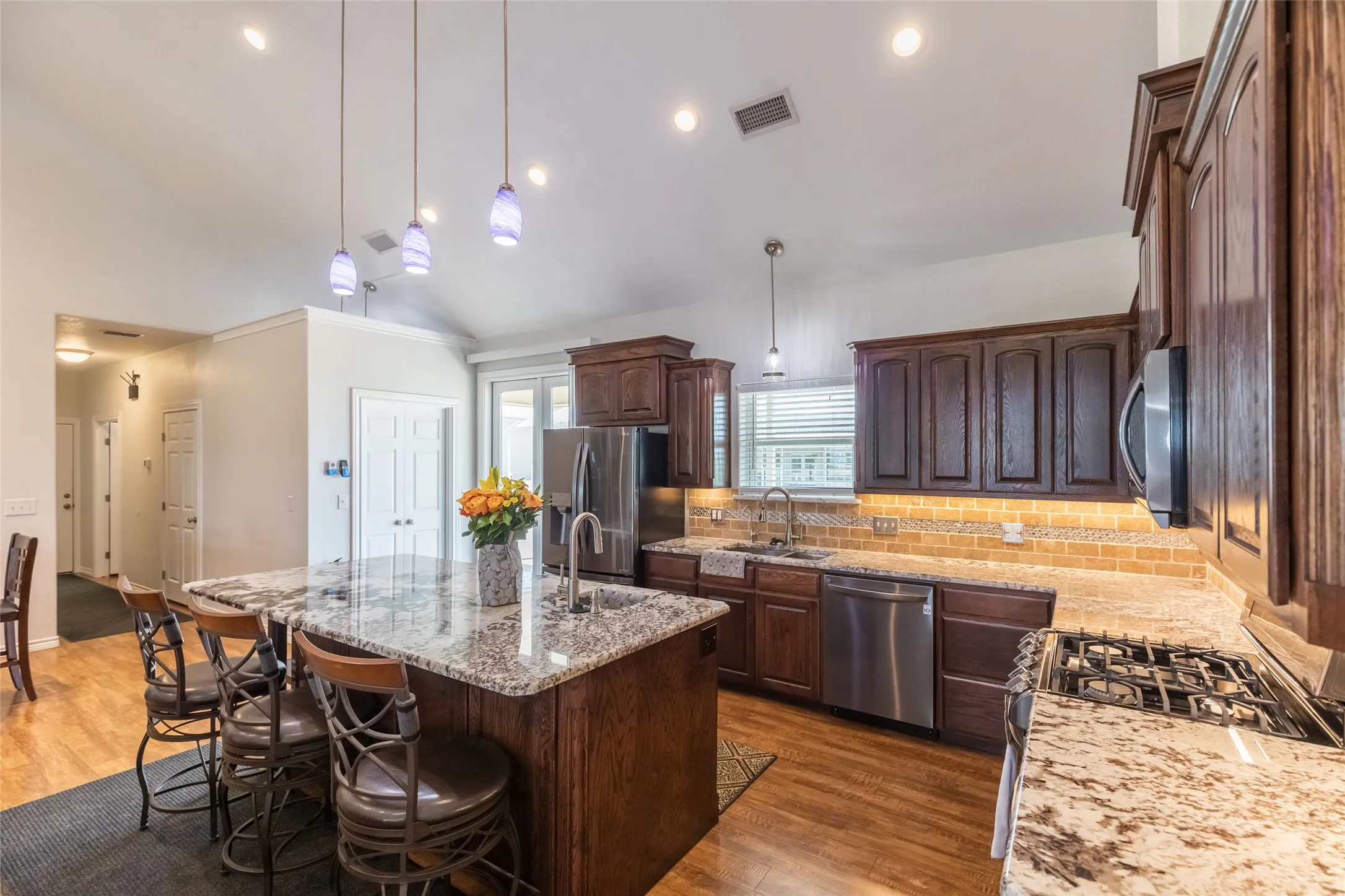 Enjoy a large walk-in pantry, kitchen island with built-in stoage, veggie and fruit sink, gas stove, and more