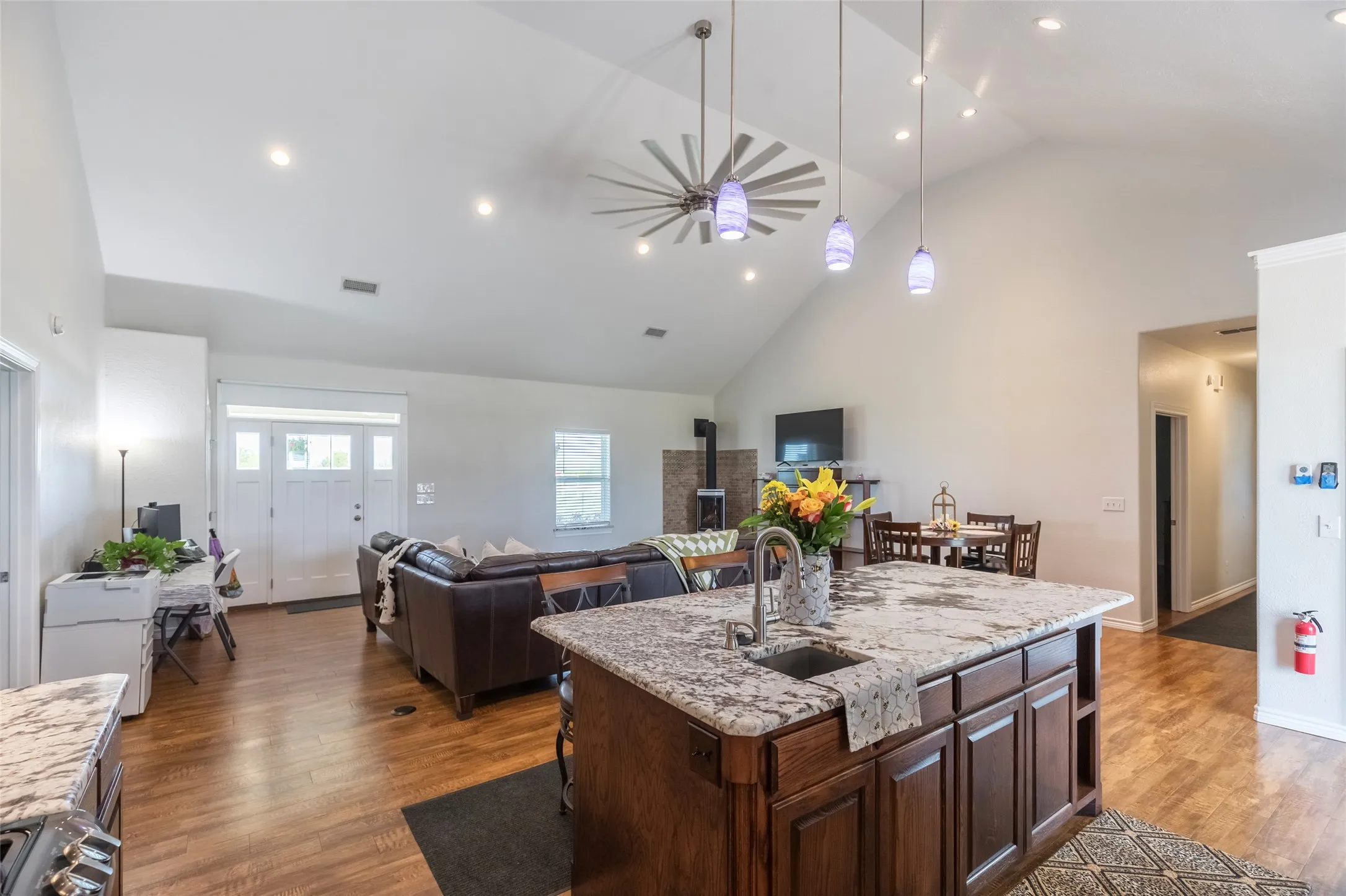 Open living area with built in shelving, propane Yodel fireplace, all dimmable lighting, and more