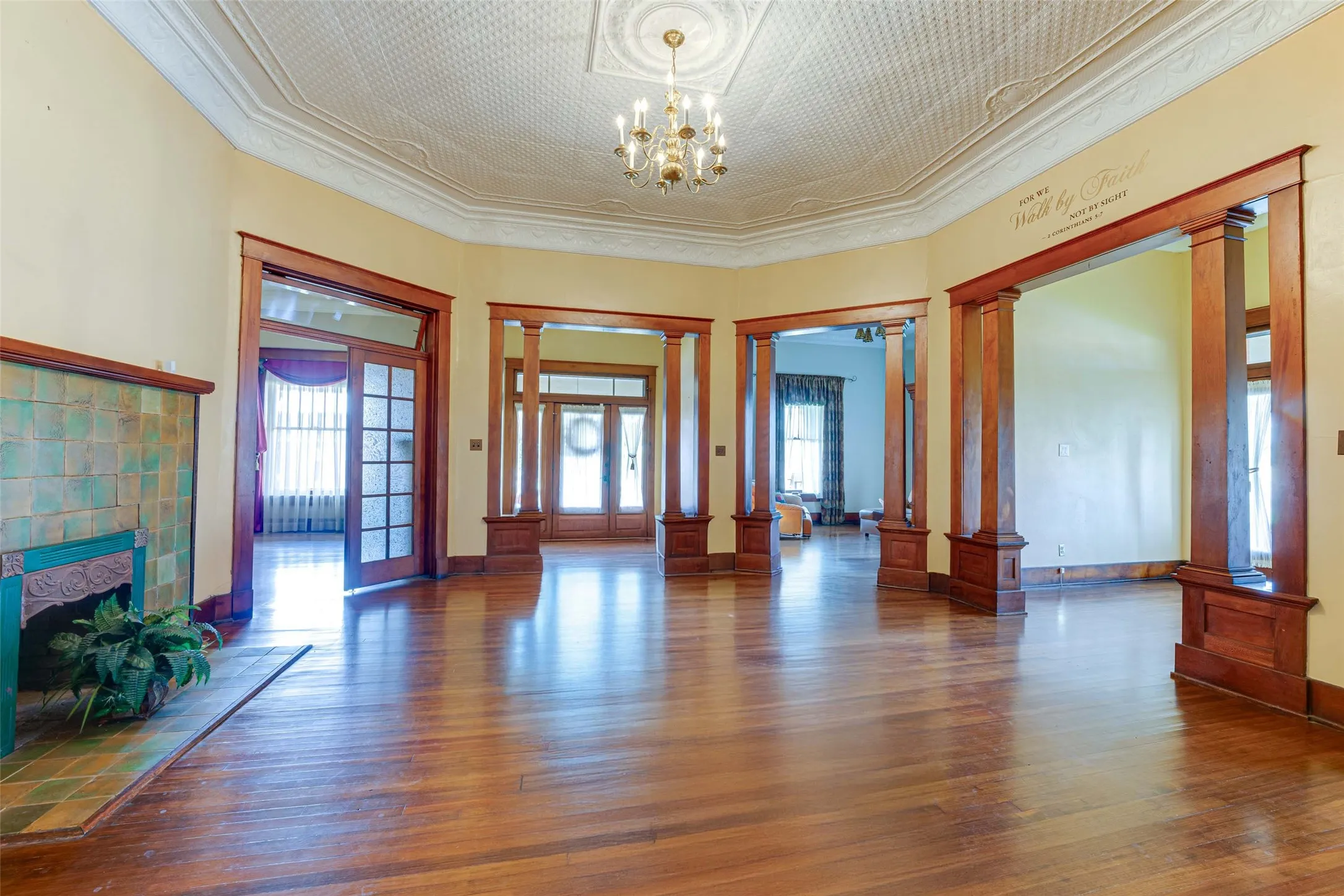 View of Primary Suite, Front Entry Door, Living Room, and Second Entry Door in Rotunda