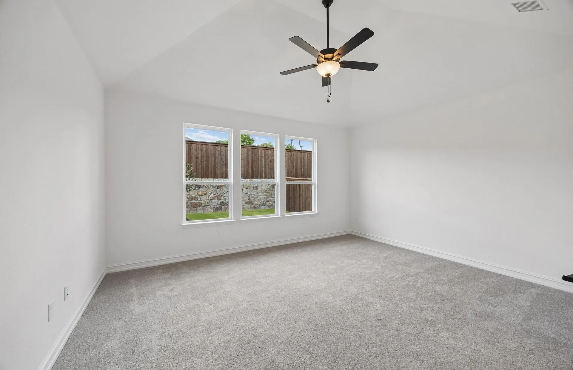 Primary bedroom with large windows
