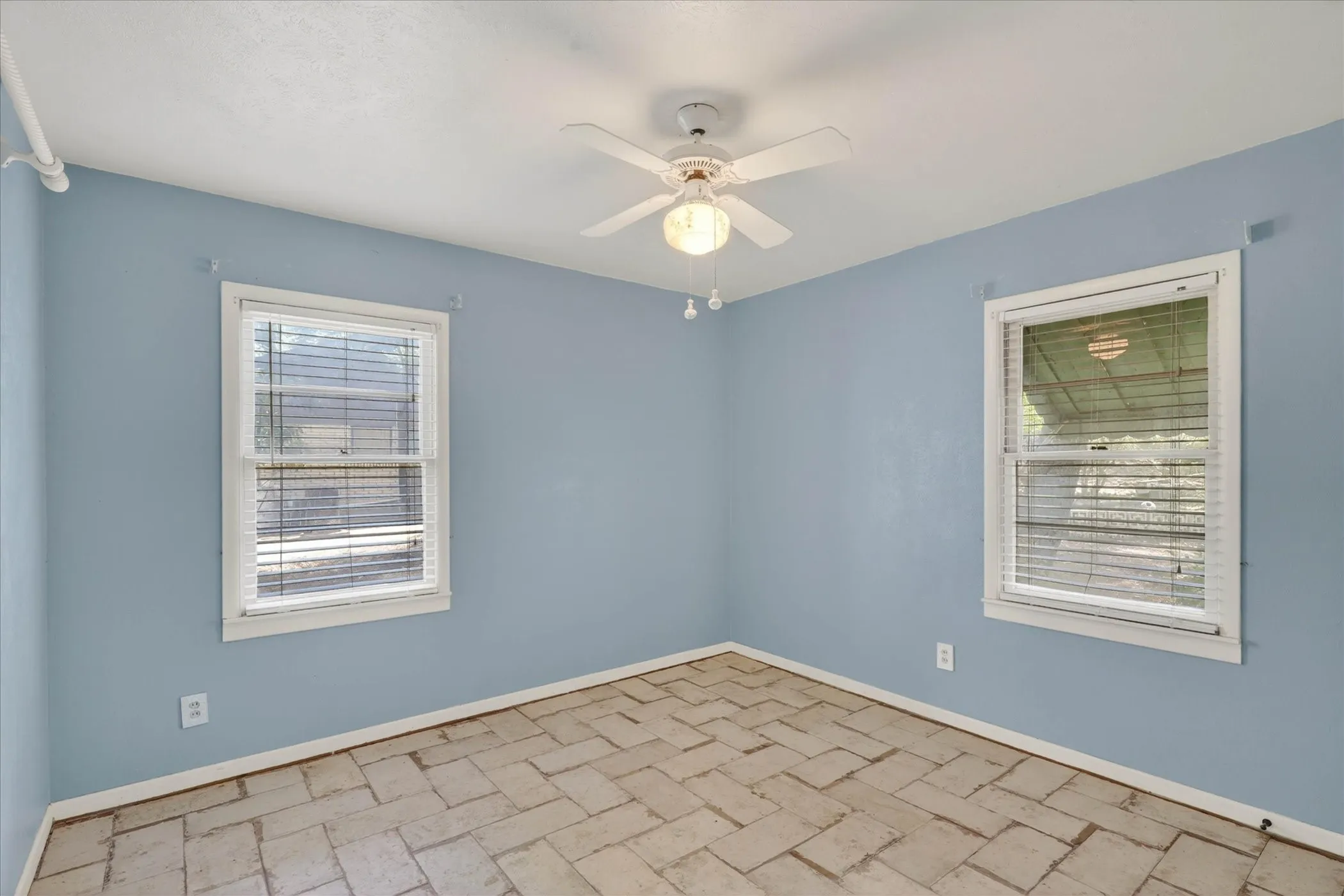 Bedroom with ceiling fan and plenty of natural light