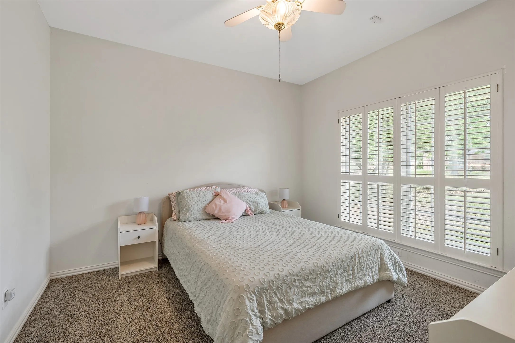 Bedroom with dark carpet and ceiling fan