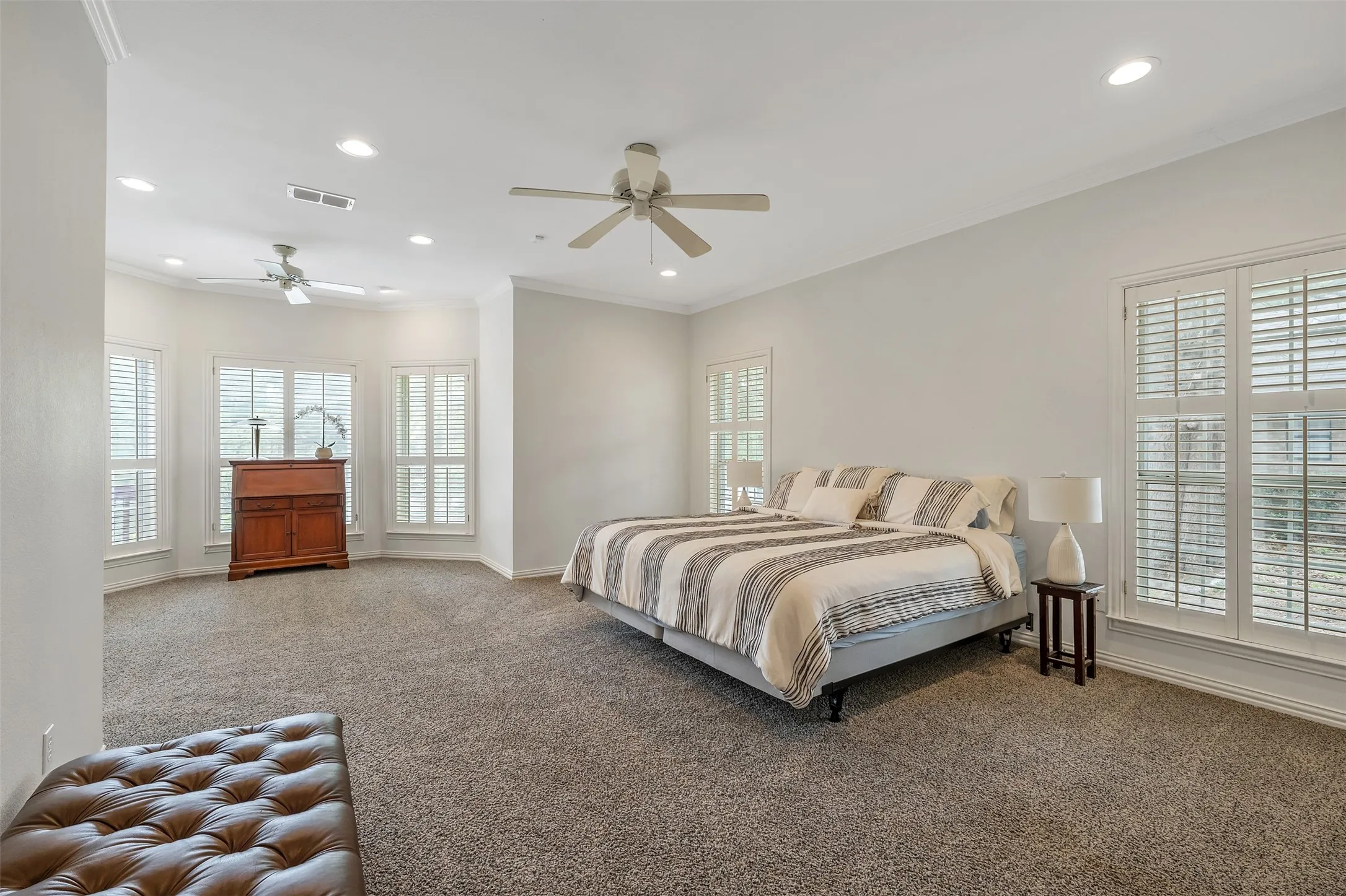 Carpeted bedroom with recessed lighting, ornamental molding, and a ceiling fan