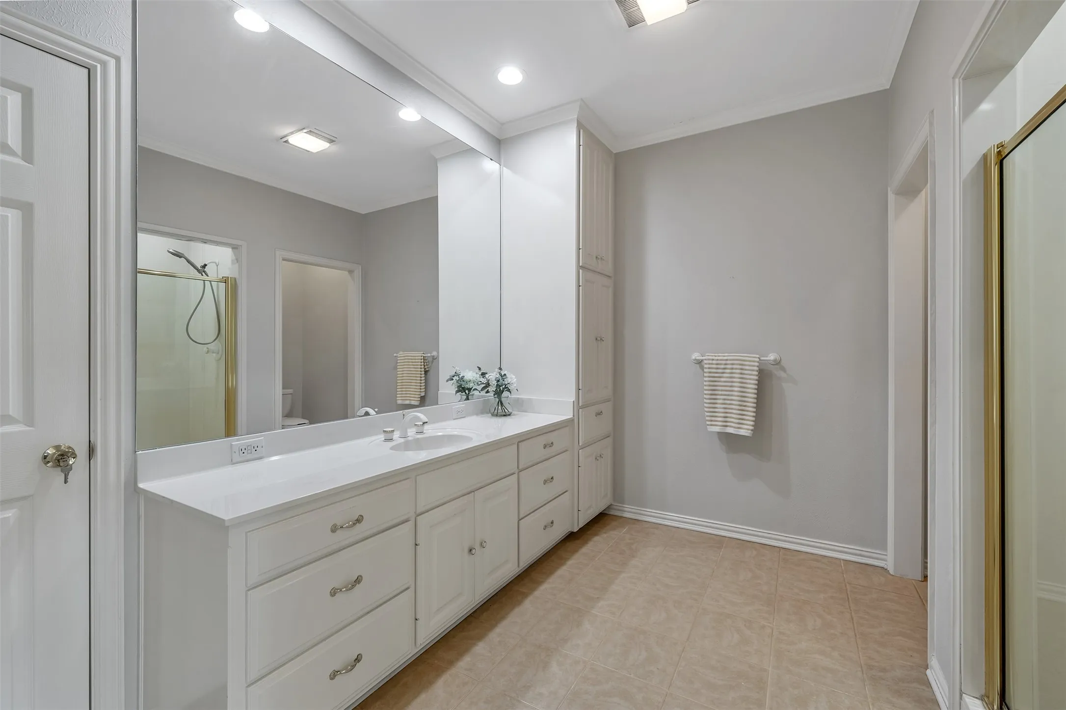 Bathroom featuring a shower stall, vanity, crown molding, and recessed lighting