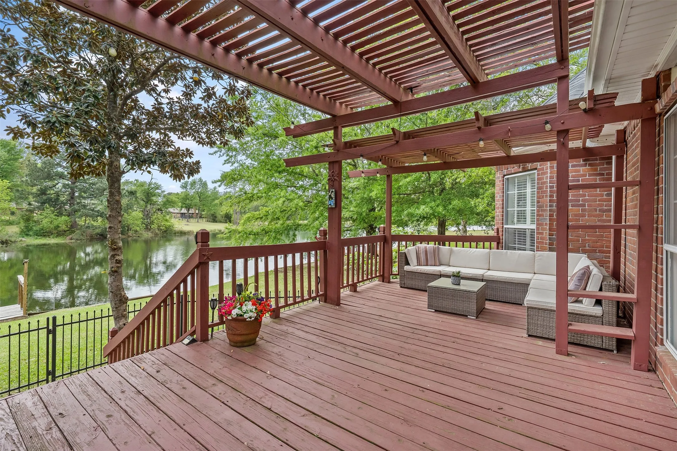 Wooden terrace featuring an outdoor hangout area and a water view