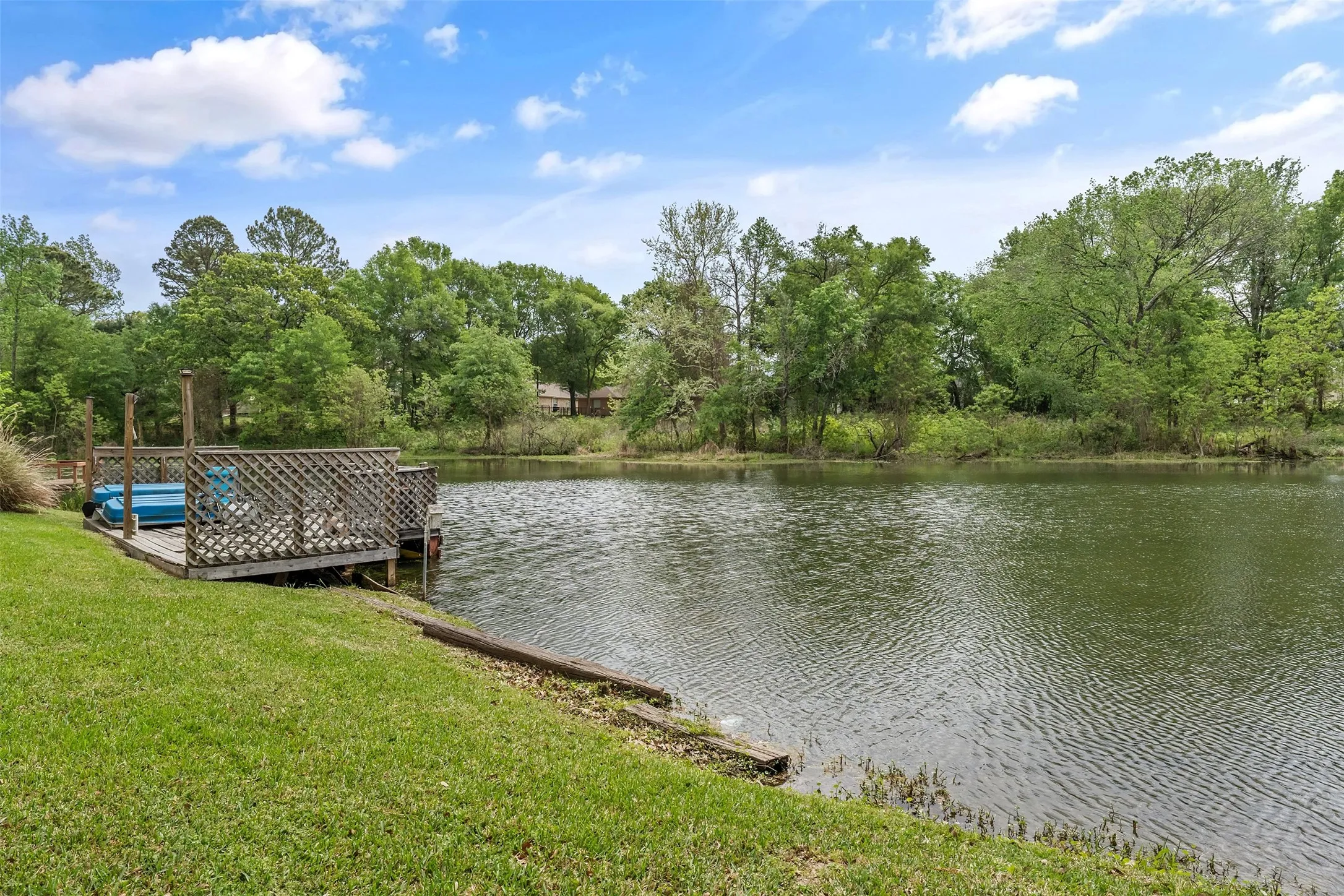 Dock with a water view and a lawn