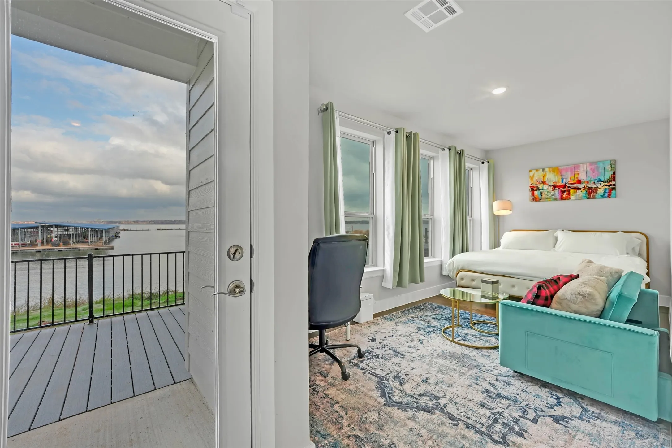 Bedroom with a water view, light wood-style floors, and recessed lighting