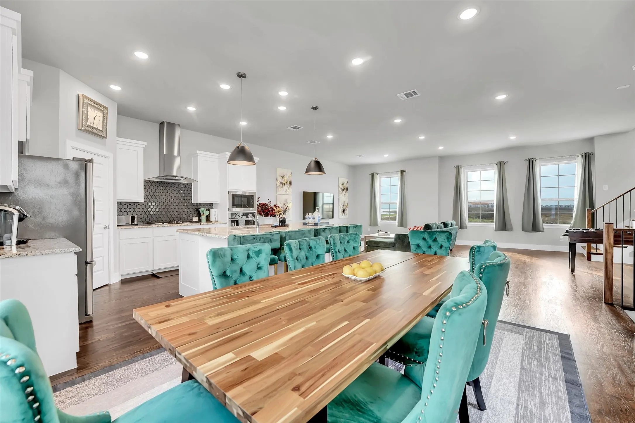 Dining area featuring dark wood-style flooring and recessed lighting