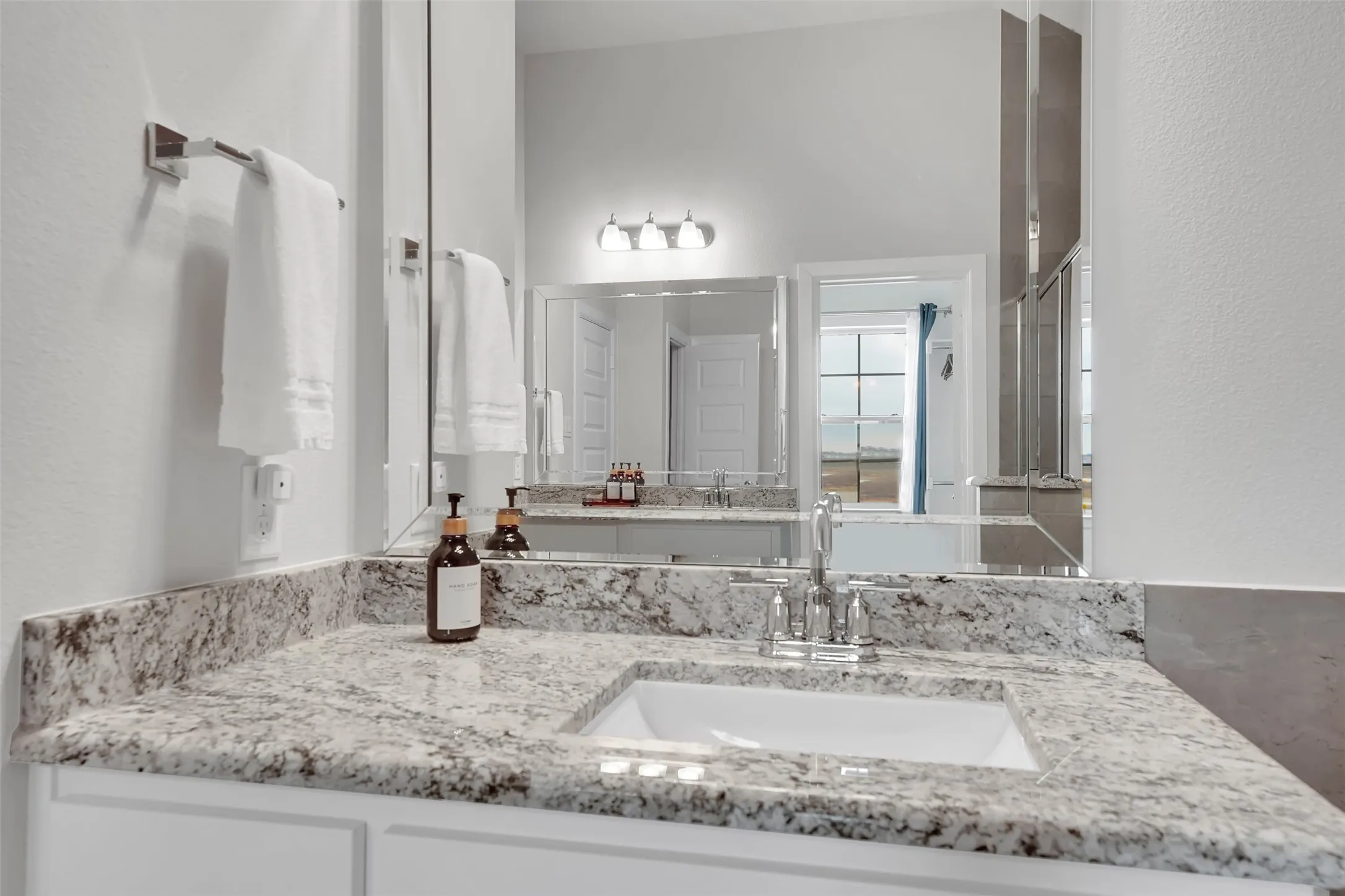 Bathroom featuring vanity and a textured wall