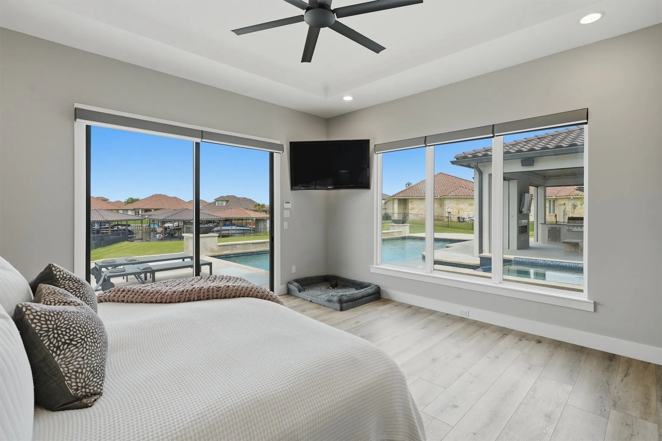 Primary Bedroom overlooks pool and lake area with easy access