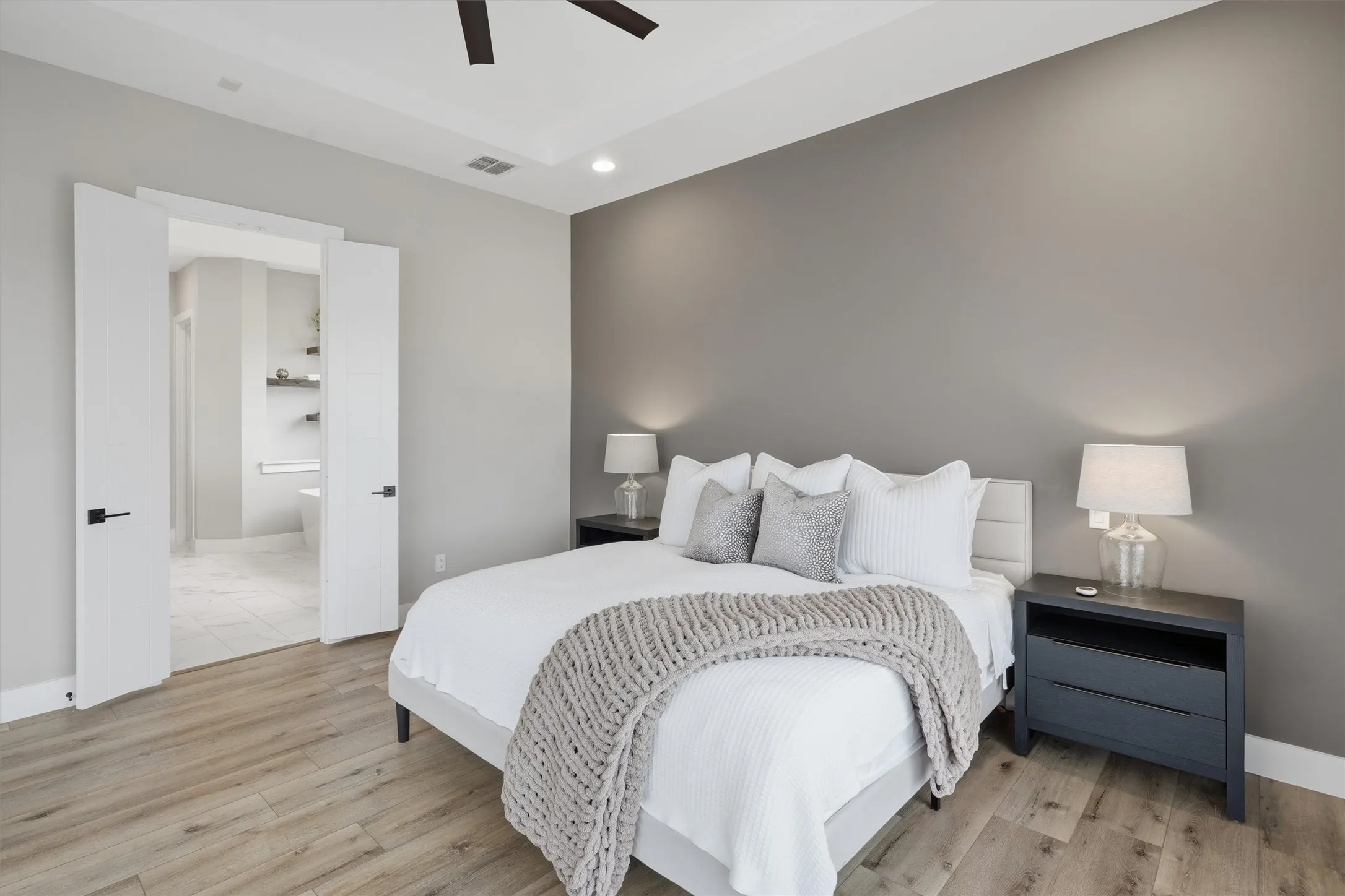 Primary Bedroom featuring light wood finished floors, ceiling fan, and recessed lighting