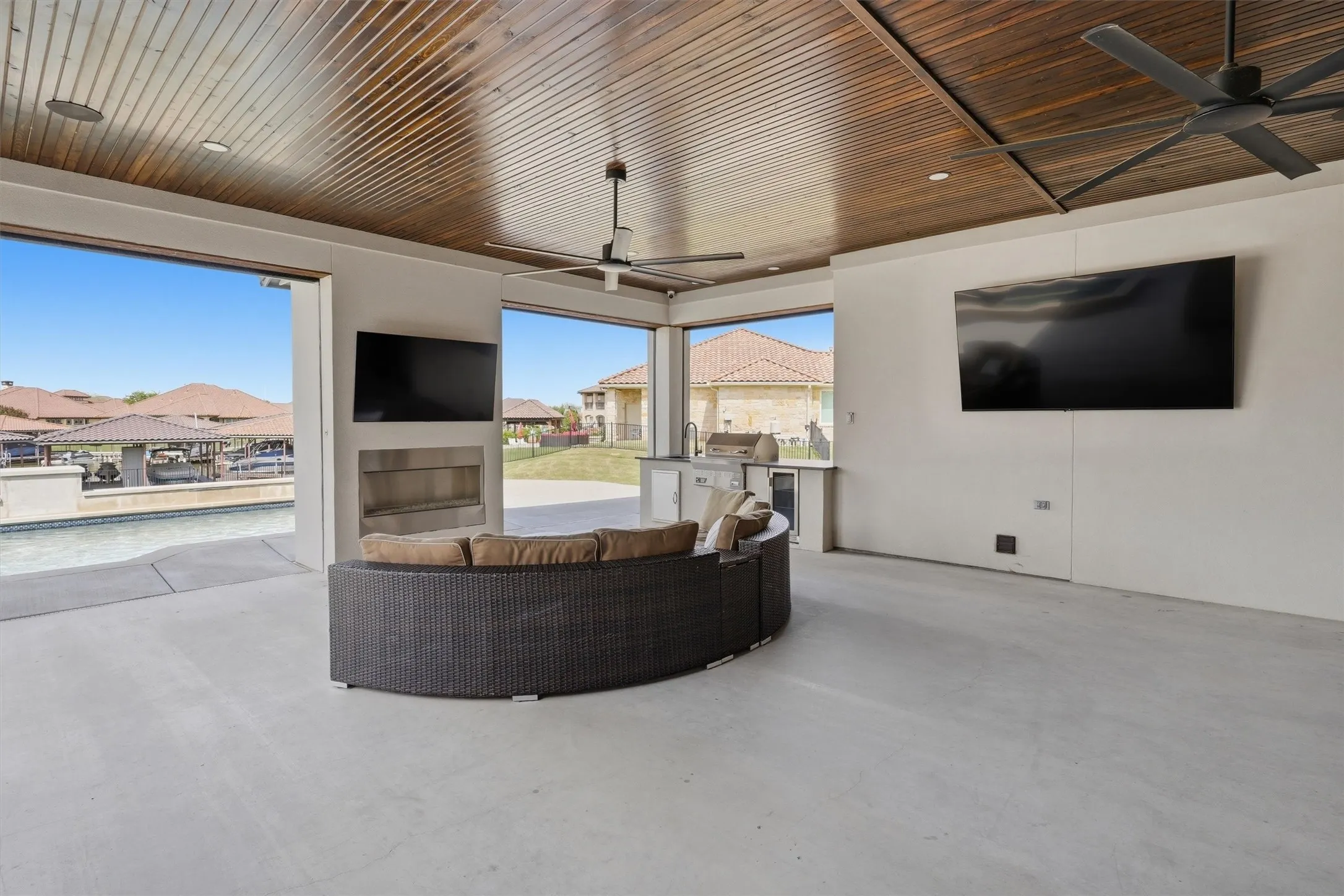 Outdoor Living space with fireplace. Opens up to Kitchen in the house to expand entertaining space