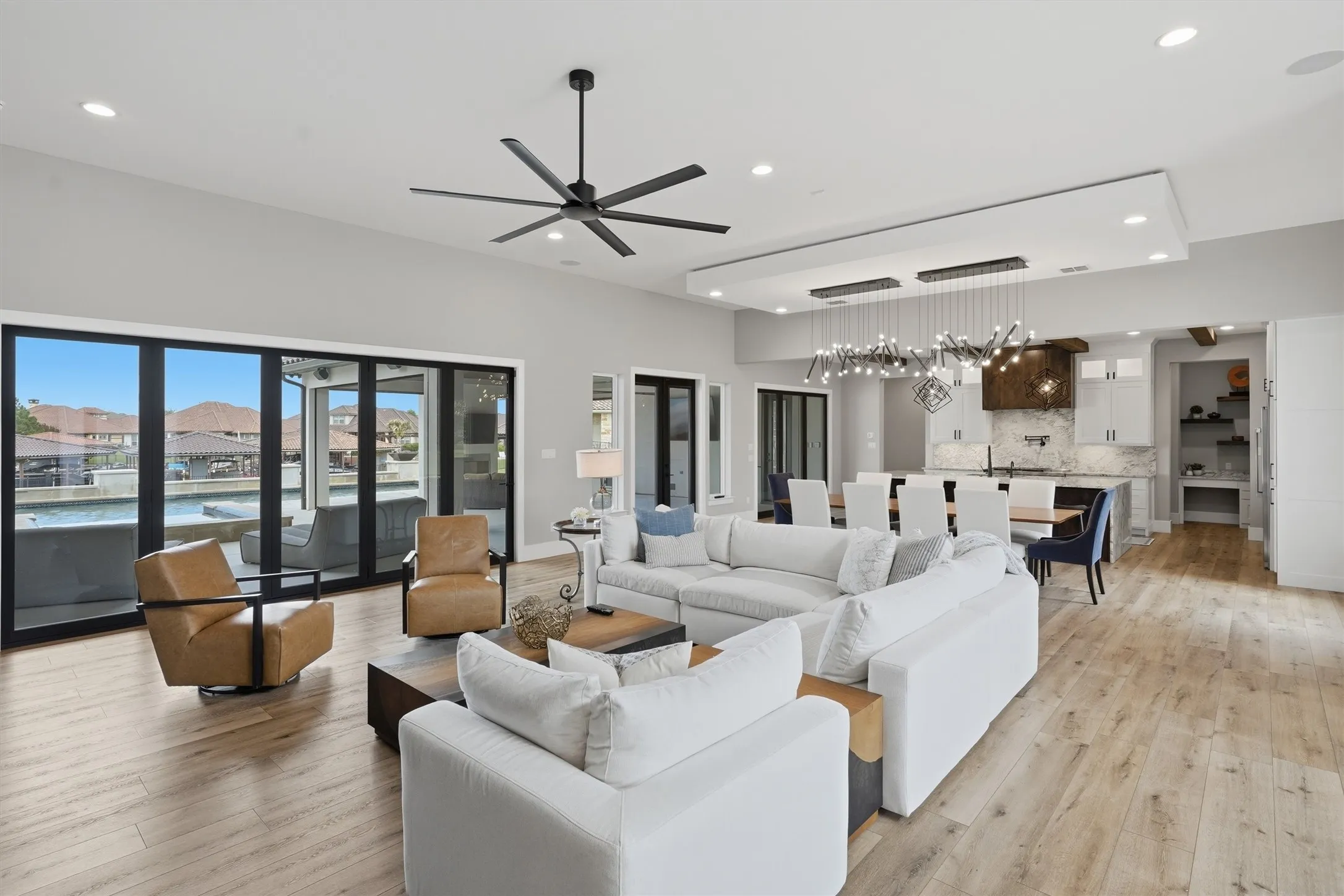 Living area featuring a ceiling fan, light wood-type flooring, and recessed lighting