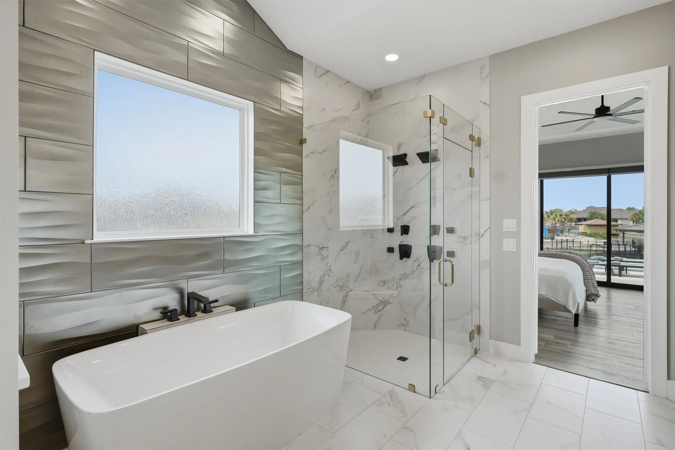 Bathroom with ensuite bath, a marble finish shower, a soaking tub, light marble finish floors, and recessed lighting