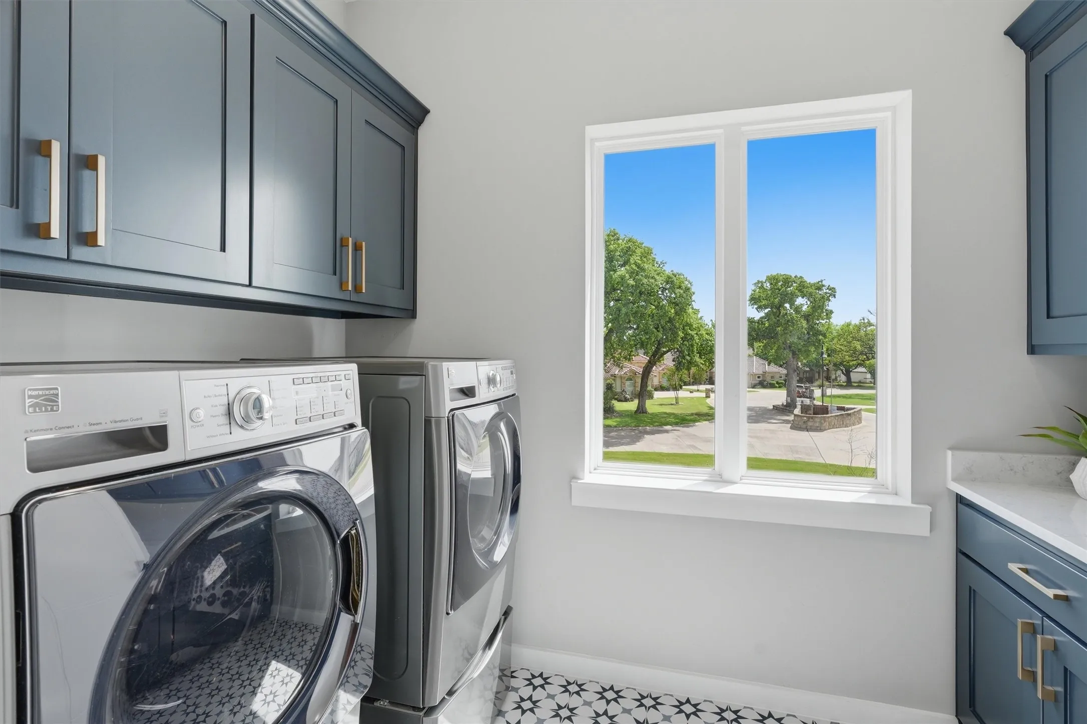 Upstairs Laundry room with cabinet space and separate washer and dryer
